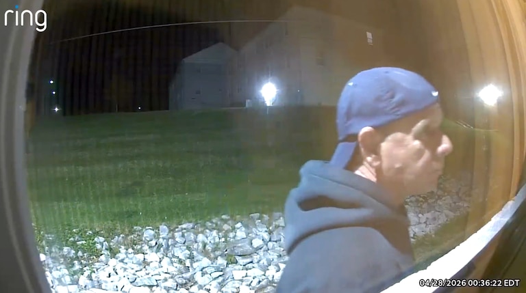 A still from Ring camera footage shows a person looking in the window of the roommates' first-floor Towson apartment on Tuesday.