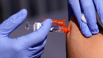 FILE - A patient is given a flu vaccine at the L.A. Care and Blue Shield of California Promise Health Plans' Community Resource Center where they were offering members and the public free flu and COVID-19 vaccines Friday, Oct. 28, 2022, in Lynwood, Calif. As Americans head into the late 2022 holiday season, a rapidly intensifying flu season is straining hospitals already overburdened with patients sick from other respiratory infections.
