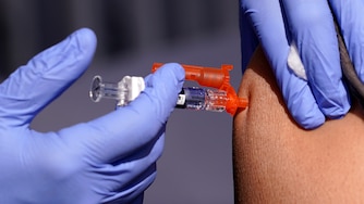 FILE - A patient is given a flu vaccine at the L.A. Care and Blue Shield of California Promise Health Plans' Community Resource Center where they were offering members and the public free flu and COVID-19 vaccines Friday, Oct. 28, 2022, in Lynwood, Calif. As Americans head into the late 2022 holiday season, a rapidly intensifying flu season is straining hospitals already overburdened with patients sick from other respiratory infections.