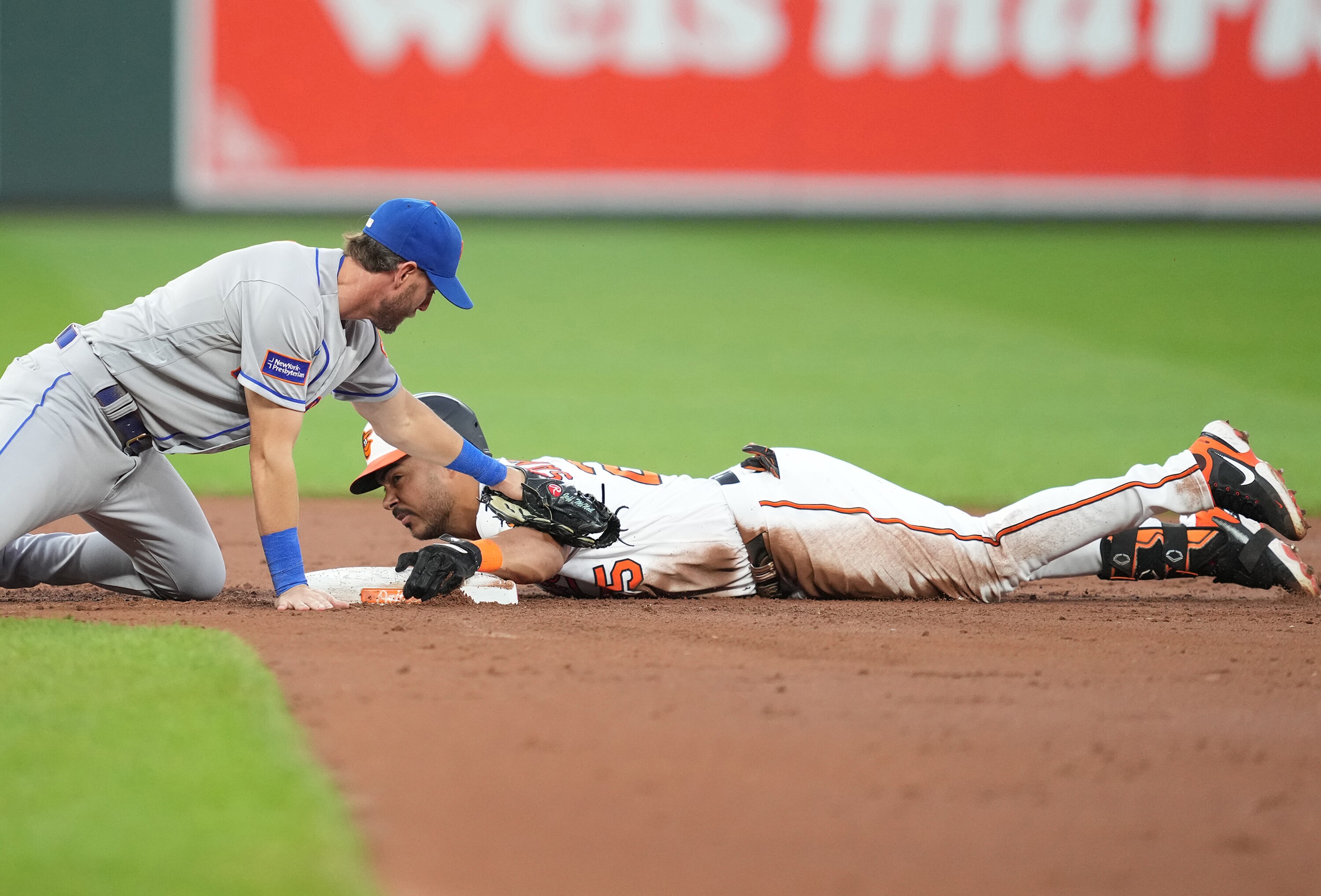 Anthony Santander doubles in the fourth inning as Jeff McNeil of the Mets applies a late tag.