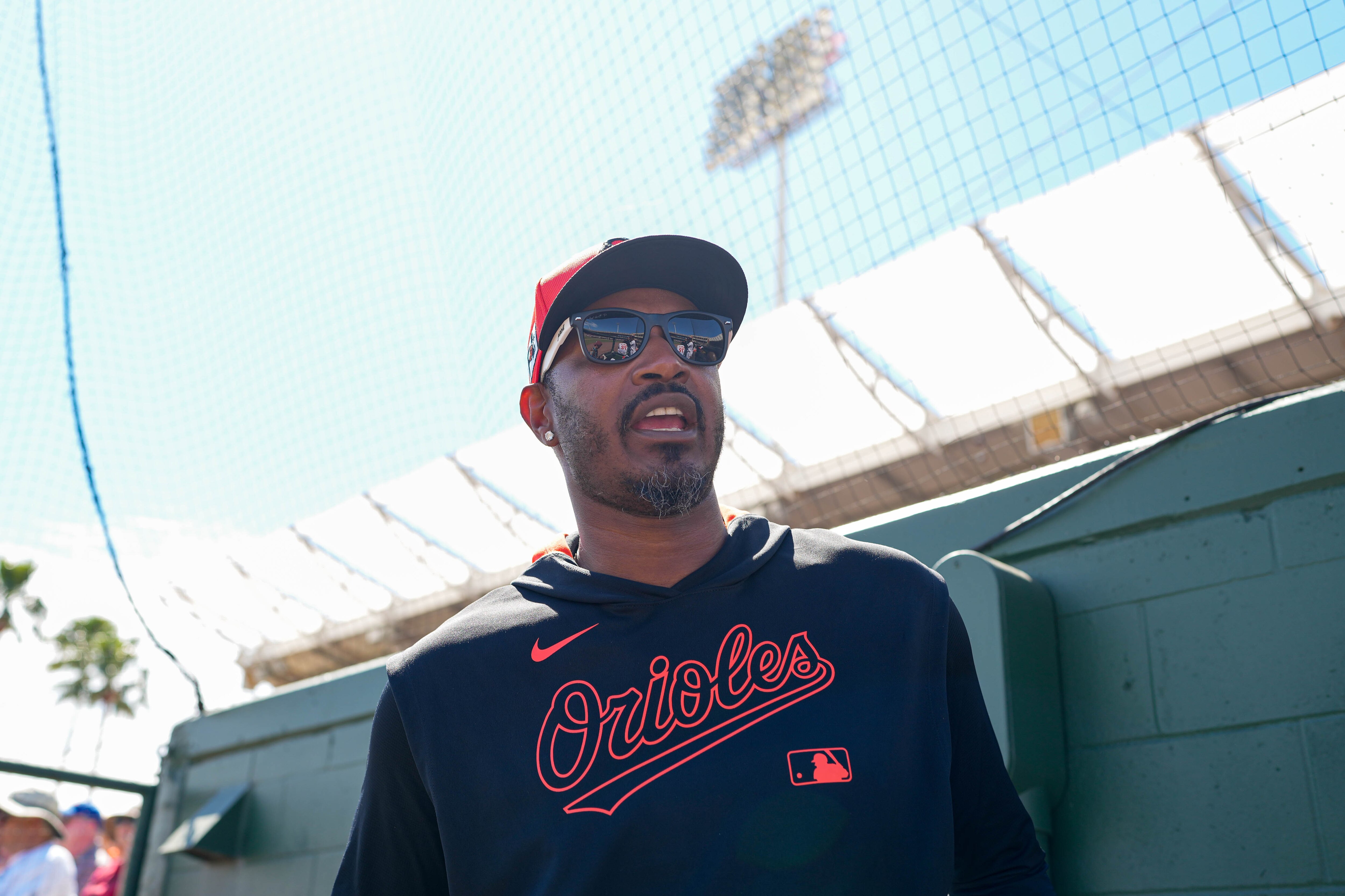 Orioles legend Adam Jones guest coaches from the photo well at Ed Smith Stadium in Sarasota, Florida, on Feb. 27.
