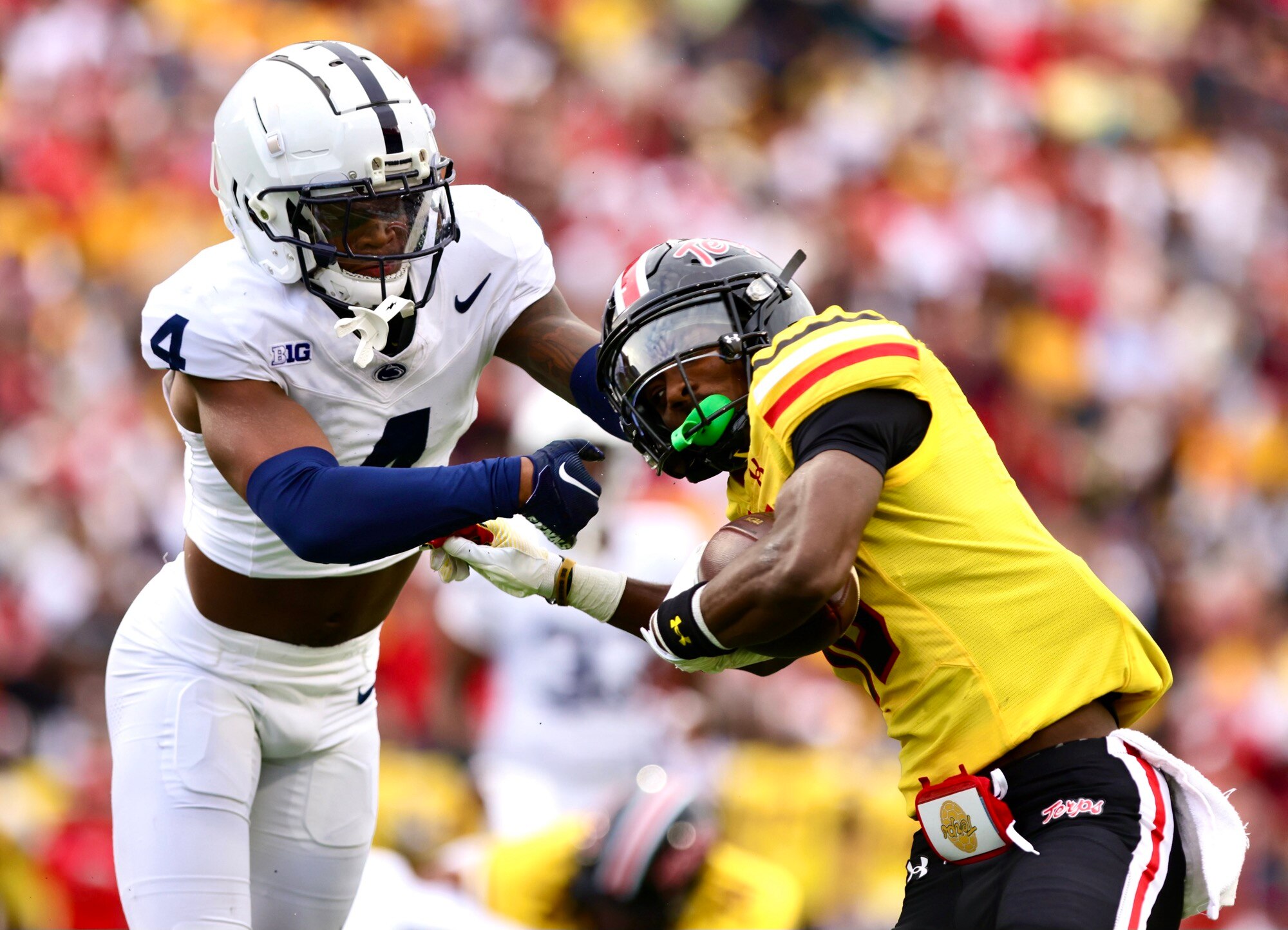 Penn State quarterback Kalen King hits the Terps' Tai Felton high. (Lexi Thompson/For The Baltimore Banner)