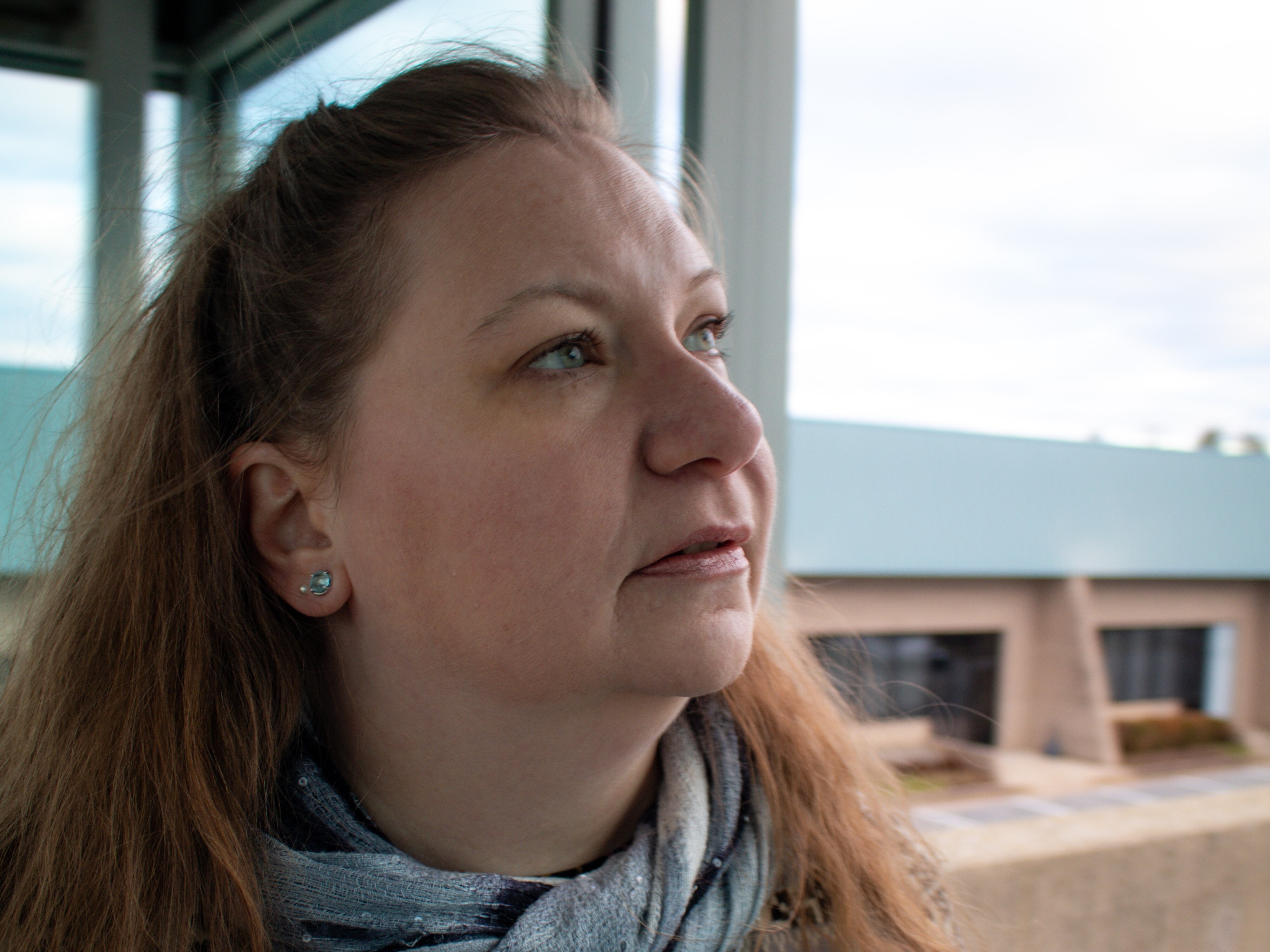 A woman looks off into the distance.