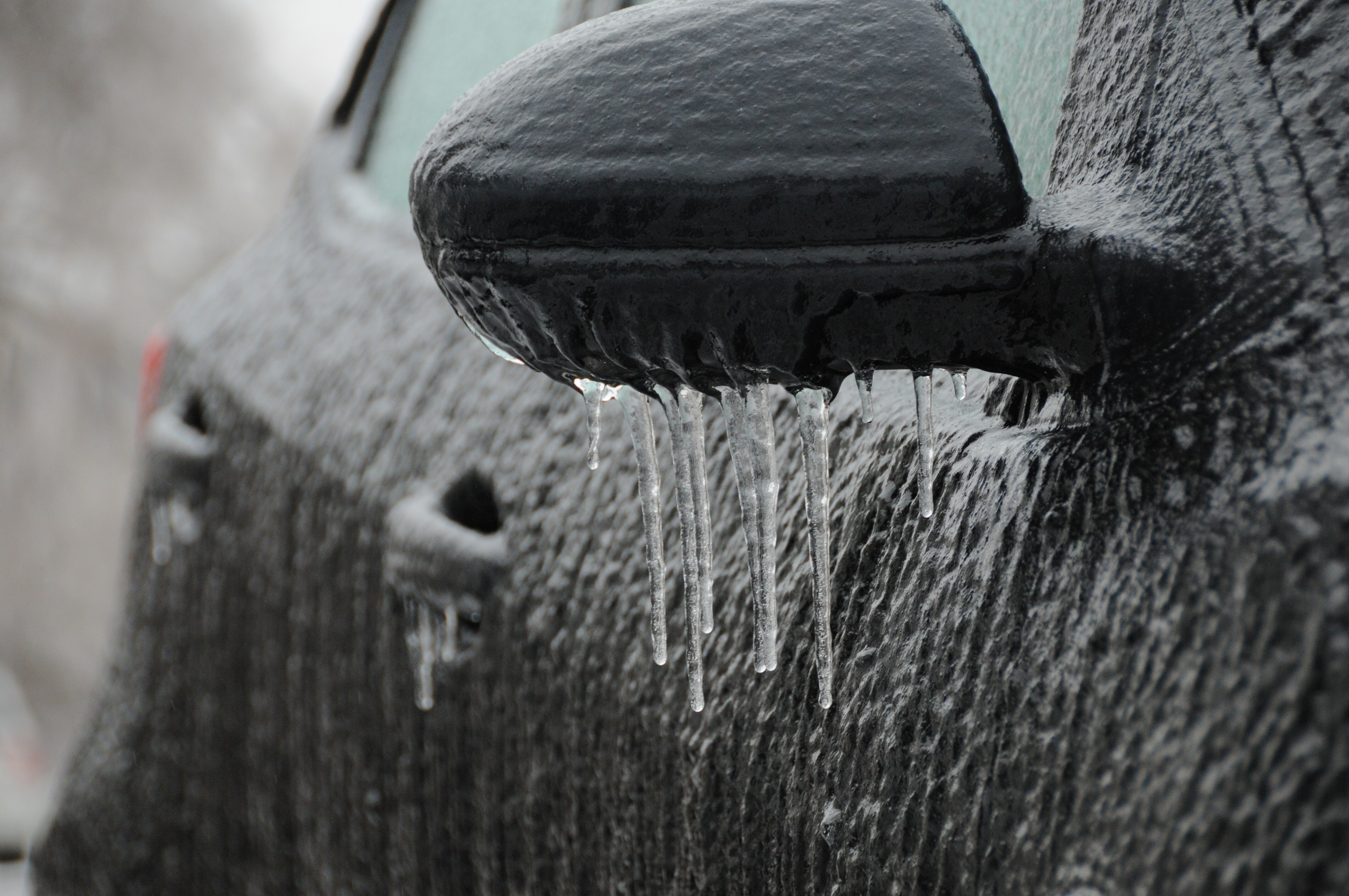 frozen car side-view mirror after ice storm
