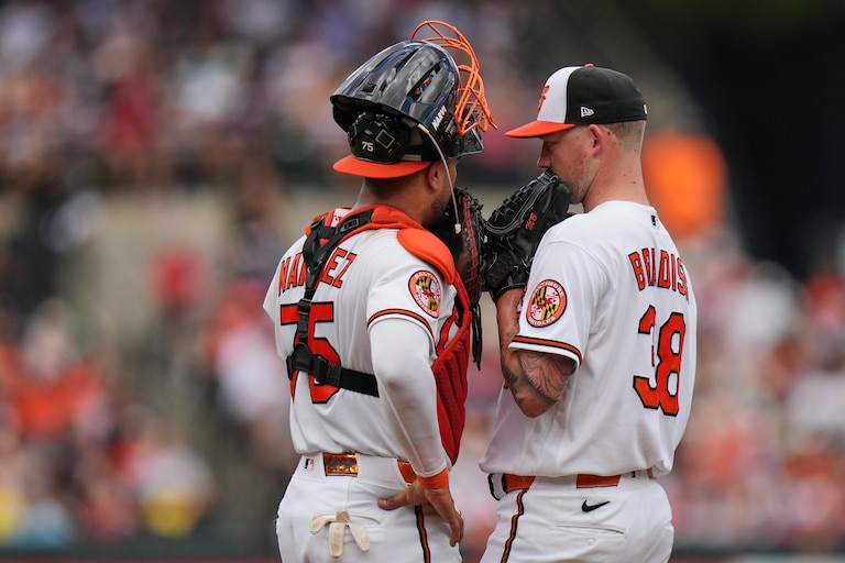 Baltimore Orioles catcher Carlos Narváez, left, talks with starting pitcher Kyle Bradish, right, during a mound visit in the second inning of a baseball game against the Boston Red Sox, Sunday, Sept. 6, 2026, in Baltimore. (AP Photo/Stephanie Scarbrough)