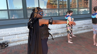 Tikia Ballard, a Woodlawn native and longtime science teacher, wore a google, waterproof camera and cape to prepare to jump off the pier at Fells Point's Bond Street Wharf as part of Waterfront Partnership's Harbor Splash on Sunday, May 31, 2026.