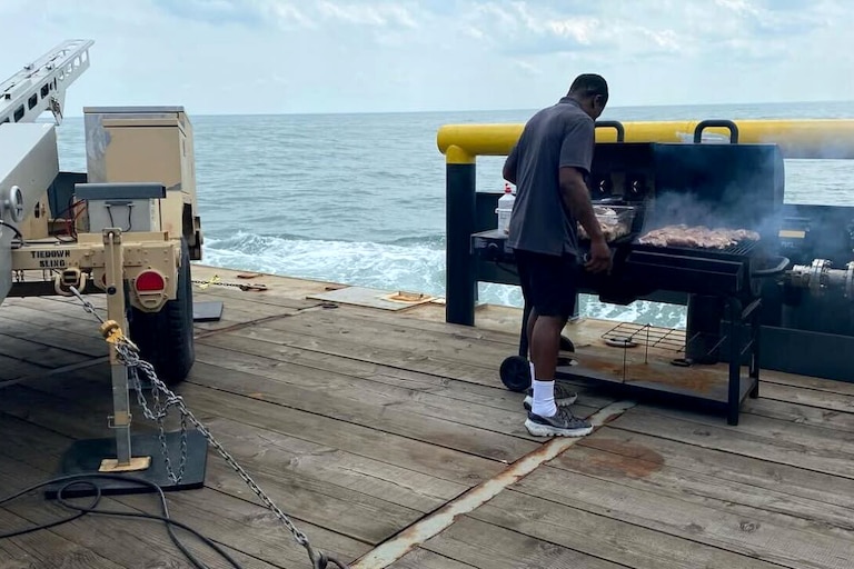 Alex Claro prepares a meal on the ocean for the military.
