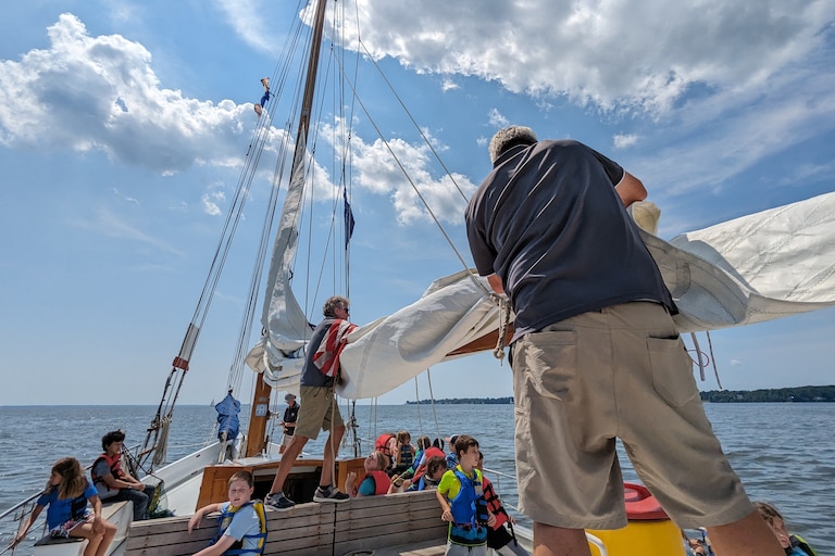 Volunteer crew Brian Fleming, left, and Philip Smith stow the mainsail aboard the Wilma Lee, an 83-year-old skipjack operated by the Annapolis Maritime Museum & Park.
