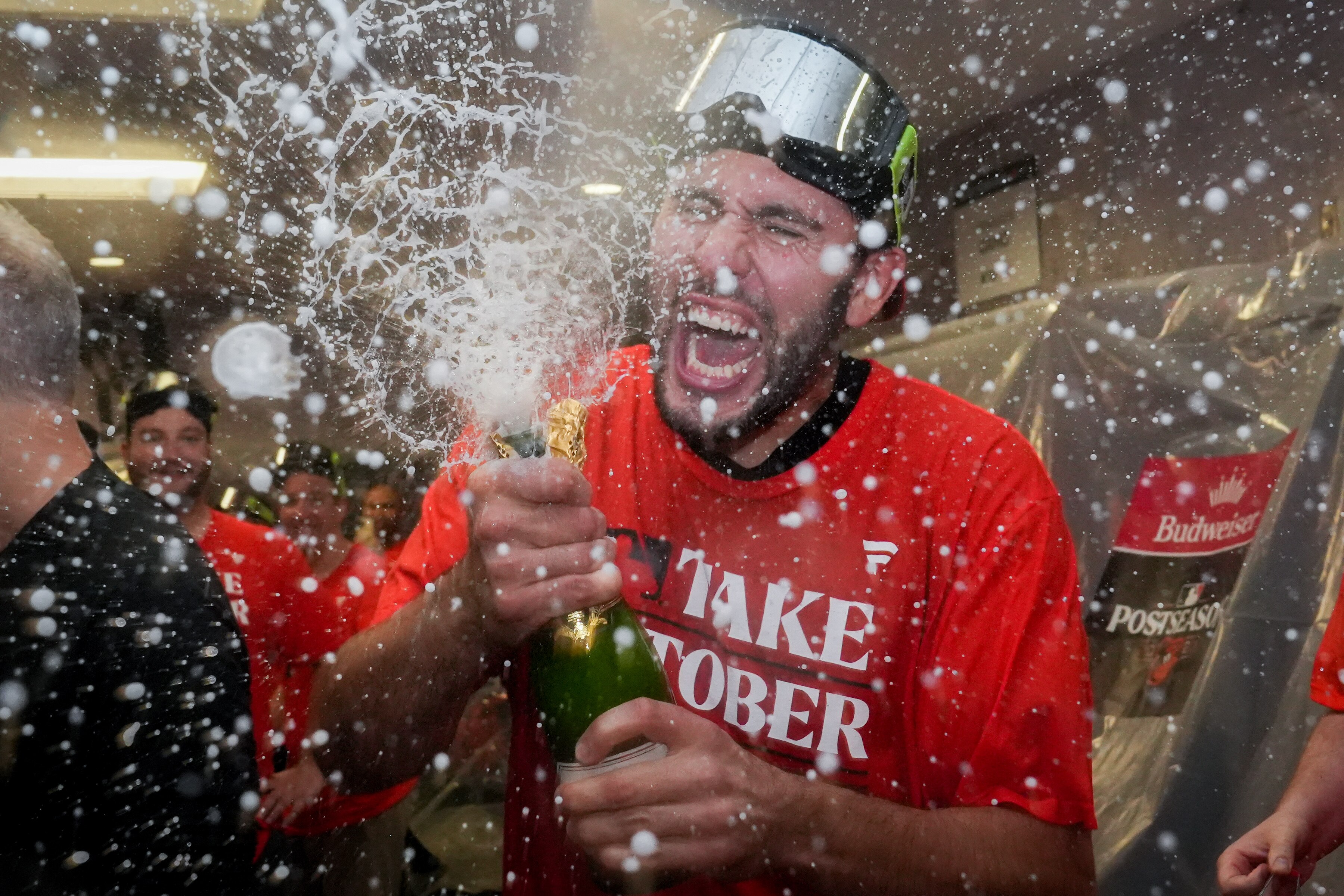 Baltimore Orioles starting pitcher Grayson Rodriguez (30) busts open a bottle of champagne in the clubhouse following the team’s playoff-clinching win against the Tampa Bay Rays on Sunday, September 17, 2023. The Orioles earned a spot in the playoffs for the first time since 2016.