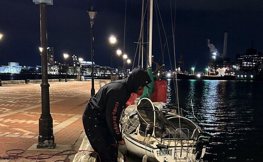 Evan Woodard magnet fishes off a pier in the Fells Point neighborhood of Baltimore on Jan. 26.