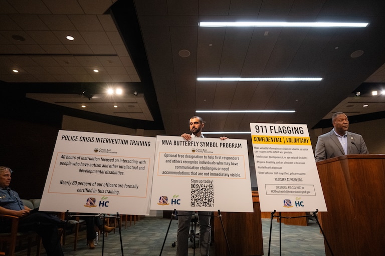 County Executive Calvin Ball, right, speaks at a press conference about a Howard County Police officer-involved shooting at Patuxent Commons.