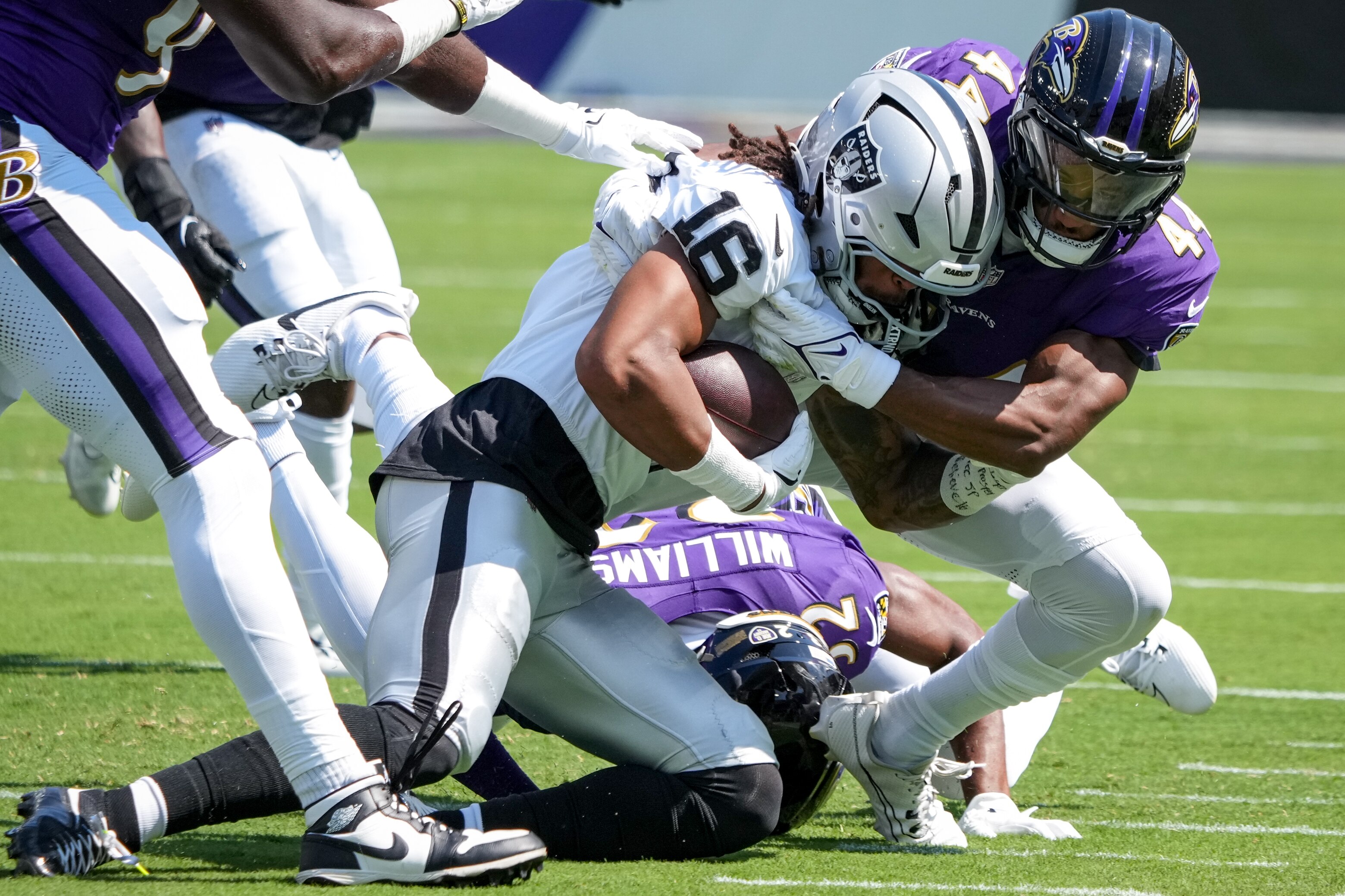Ravens cornerback Marlon Humphrey tackles Raiders wide receiver Jakobi Meyers last month.