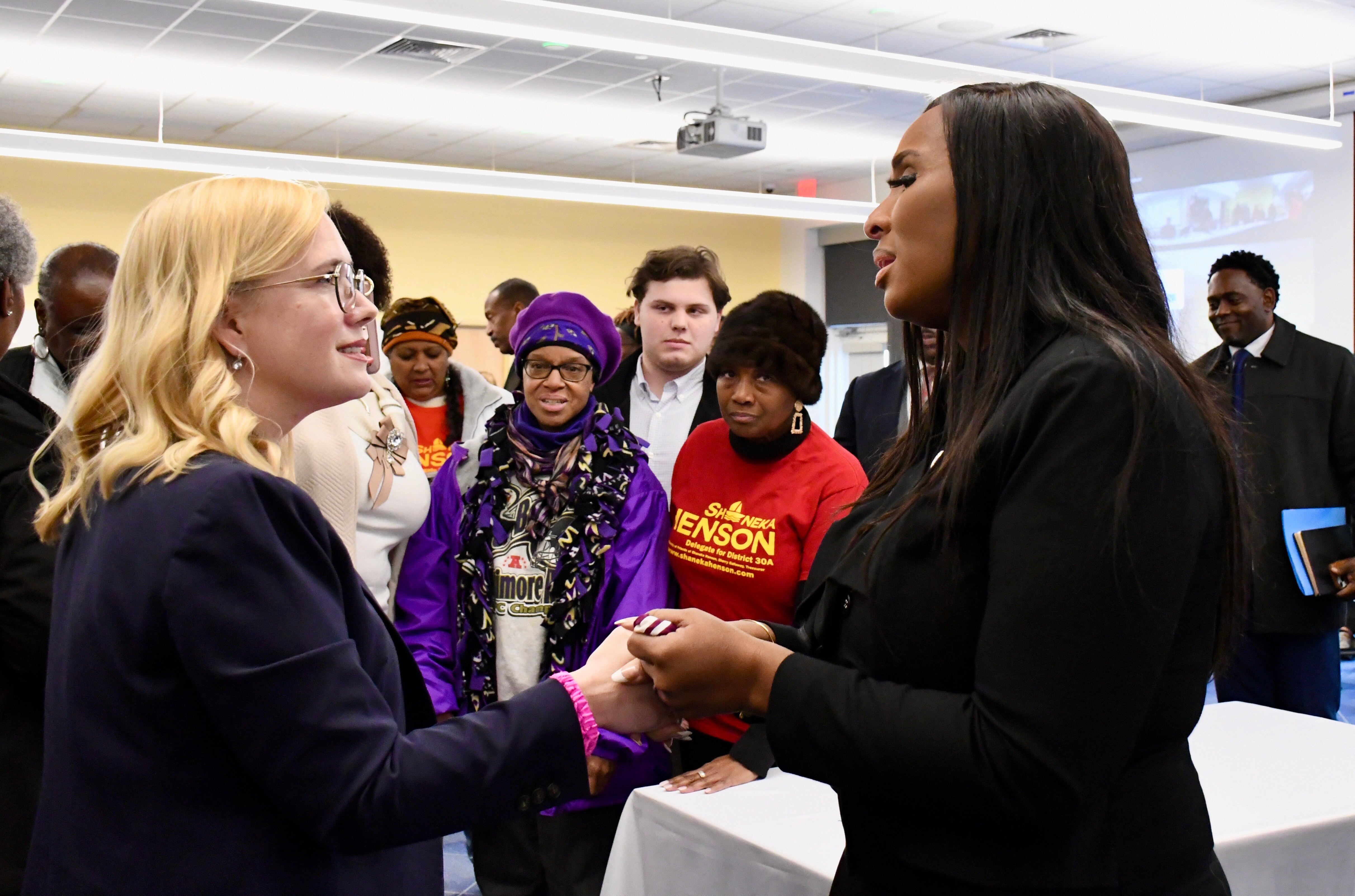 Del. Dana Jones, left, and Del. Shaneka Henson share a few words after Henson was selected by the Anne Arundel County Democratic Central Committee to fill a vacancy in the state Senate. The meeting was held at the Busch Annapolis Library on Saturday, Jan. 4, 2025.