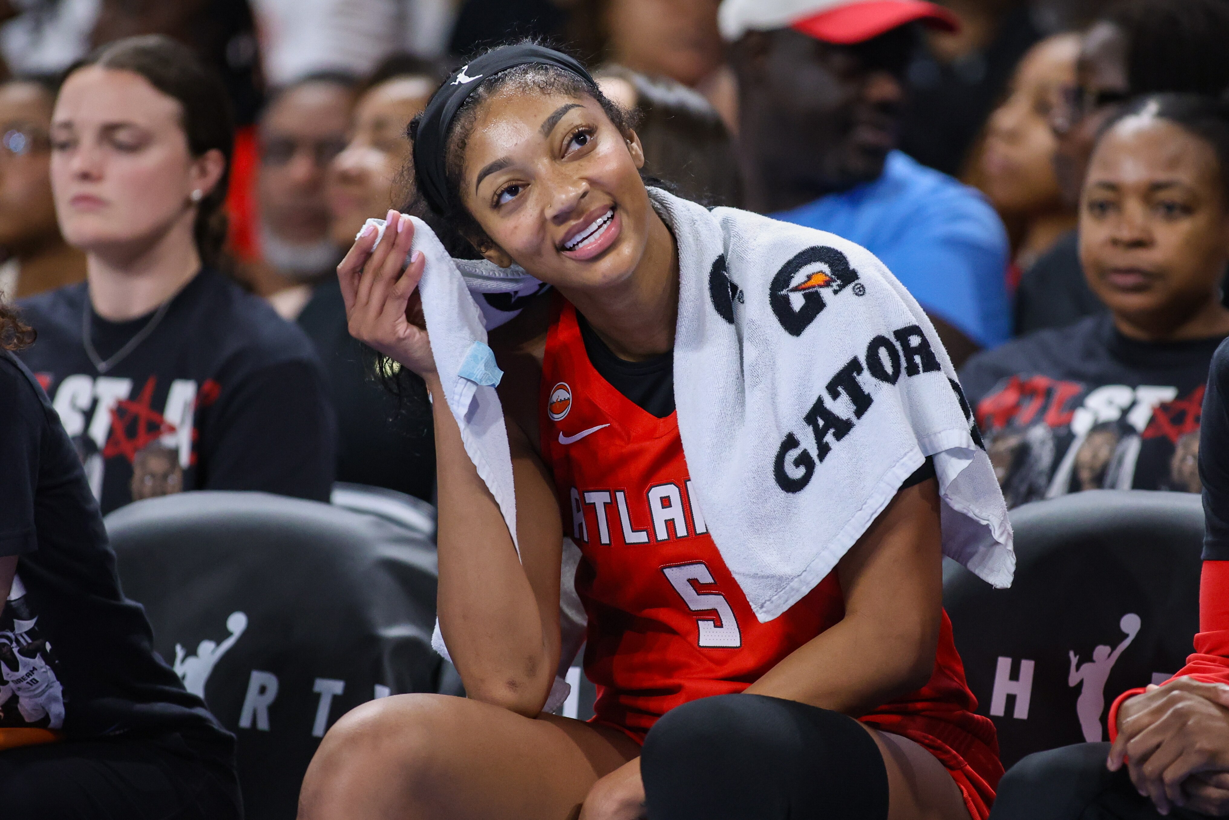 Angel Reese rests on the bench Sunday during the Dream’s game against Chicago.