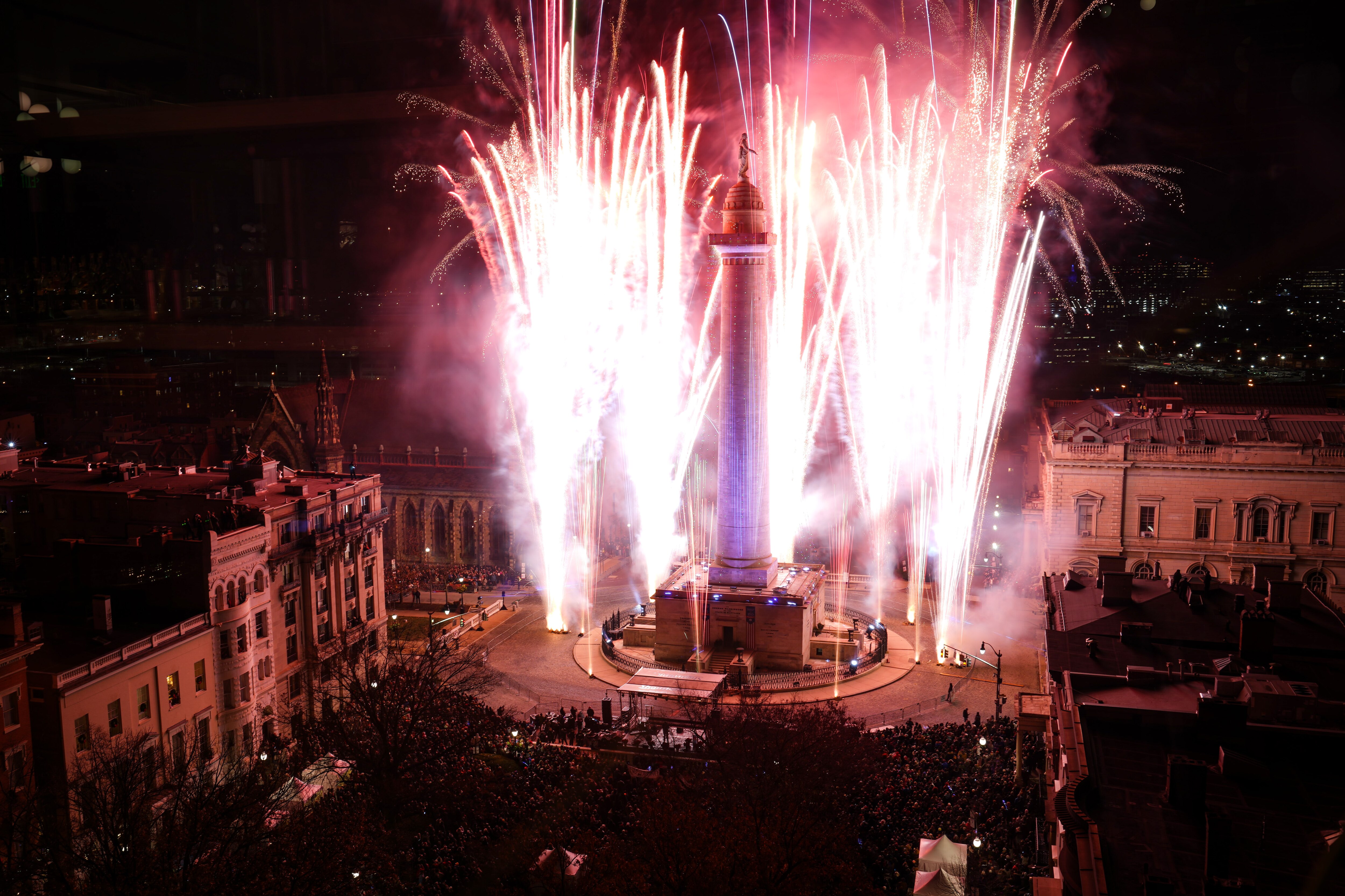 Fireworks light up the sky around the Washington Monument during the 52nd Monument Lighting at Mount Vernon Place on Thursday, December 7, 2023.
