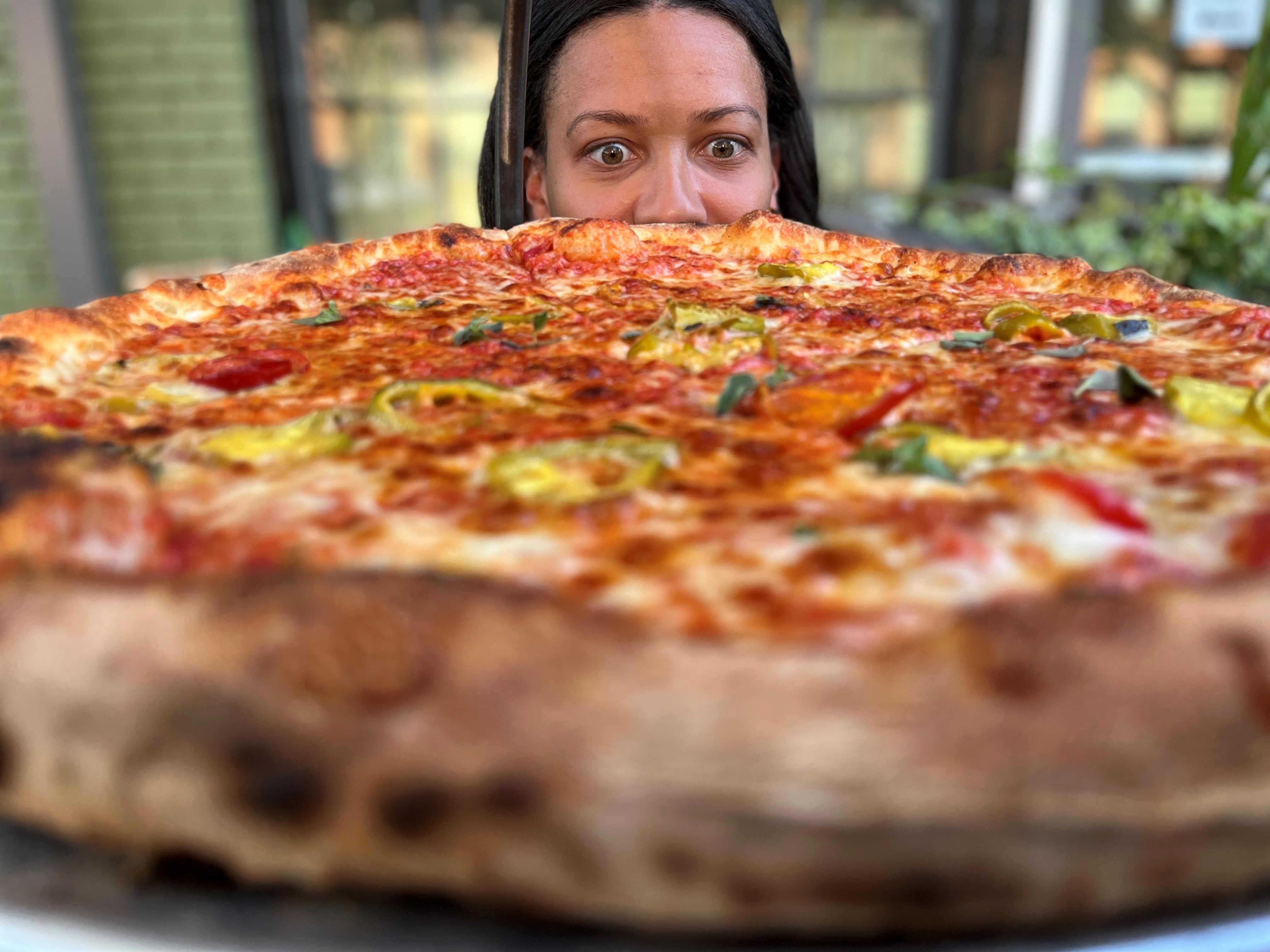 Jamyla Krempel stares down a JBGB's pizza.