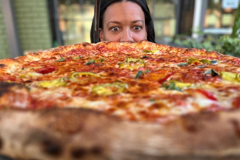 Jamyla Krempel stares down a JBGB's pizza.