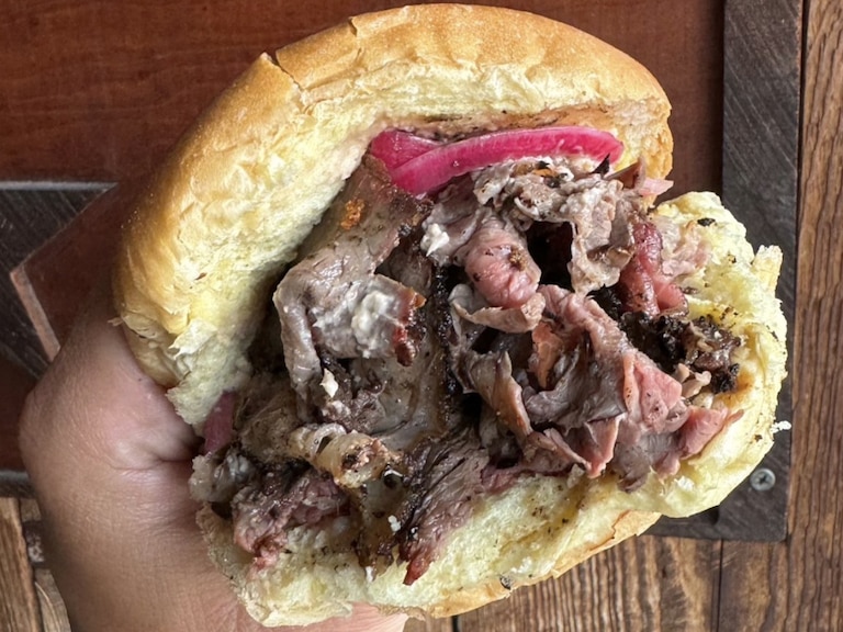 Illegal Tender Pit Beef's overstuffed sandwich has the unmistakable flavor of meat cooked over an open fire.