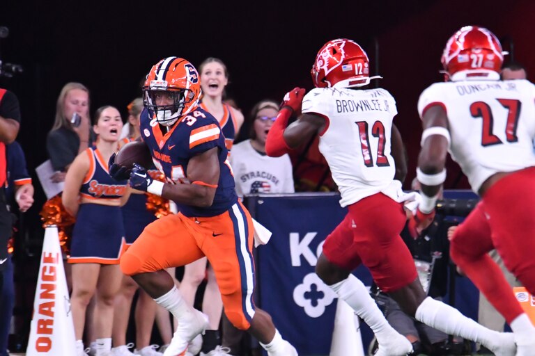 Syracuse Orange running back Sean Tucker (34) runs against Louisville Cardinals cornerback Jarvis Brownlee (12) in the first quarter at JMA Wireless Dome.