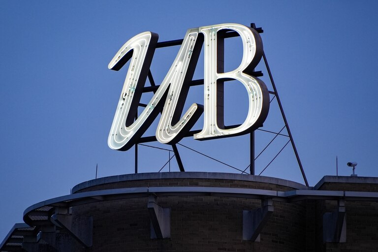 A sign for the University of Baltimore sits on top of one of the campus buildings.
