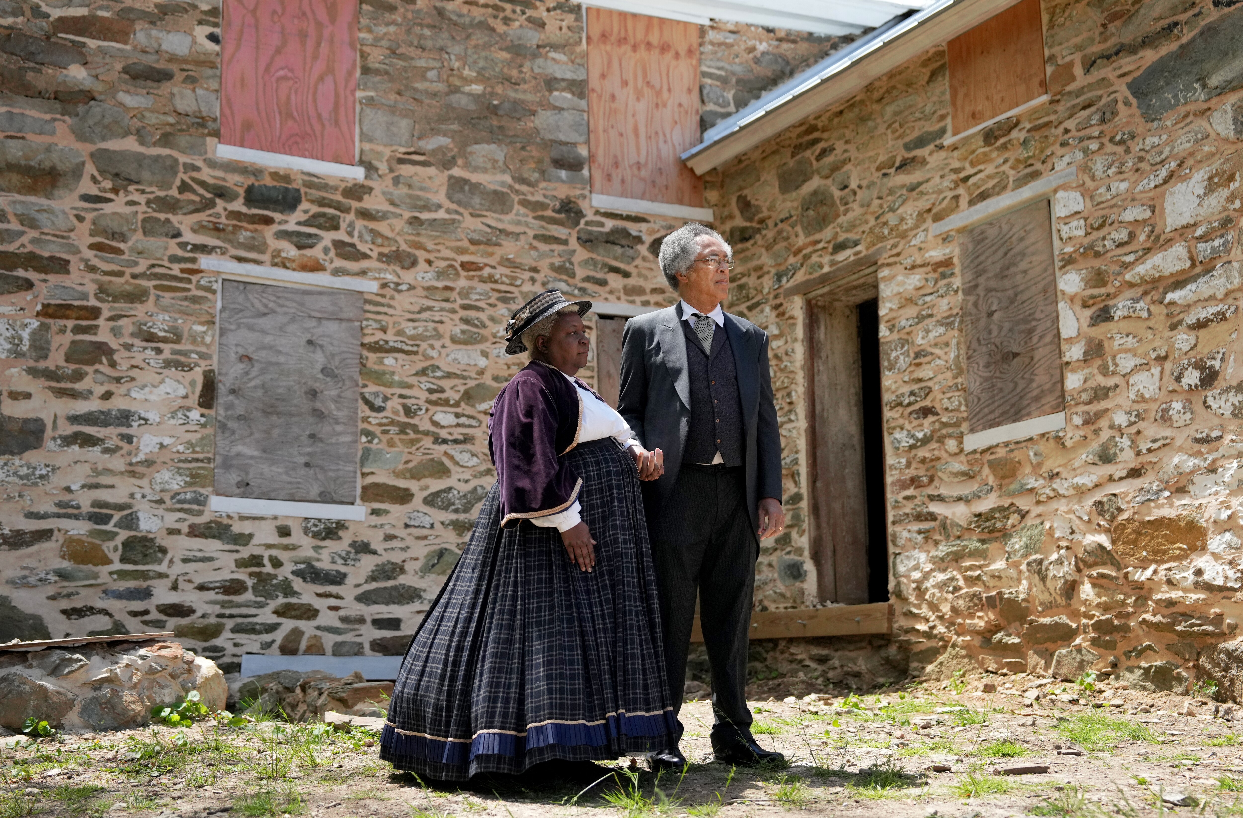 Andrea and Herold Blackford of the Washington Revels’ Jubilee Voices stand dressed as Harriet and Enoch Howard in front of the Greenbury House during the dedication ceremony of Freedman’s State Historical Park on Friday.