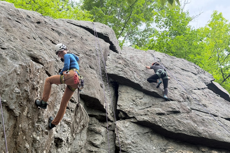 Climbing guide Eunny Jang, left, of Rockville-based East Outdoors ascends 50-foot metamorphic rock on May 26, 2026.