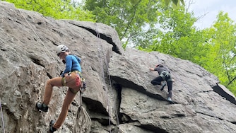 Climbing guide Eunny Jang, left, of Rockville-based East Outdoors ascends 50-foot metamorphic rock on May 26, 2026.