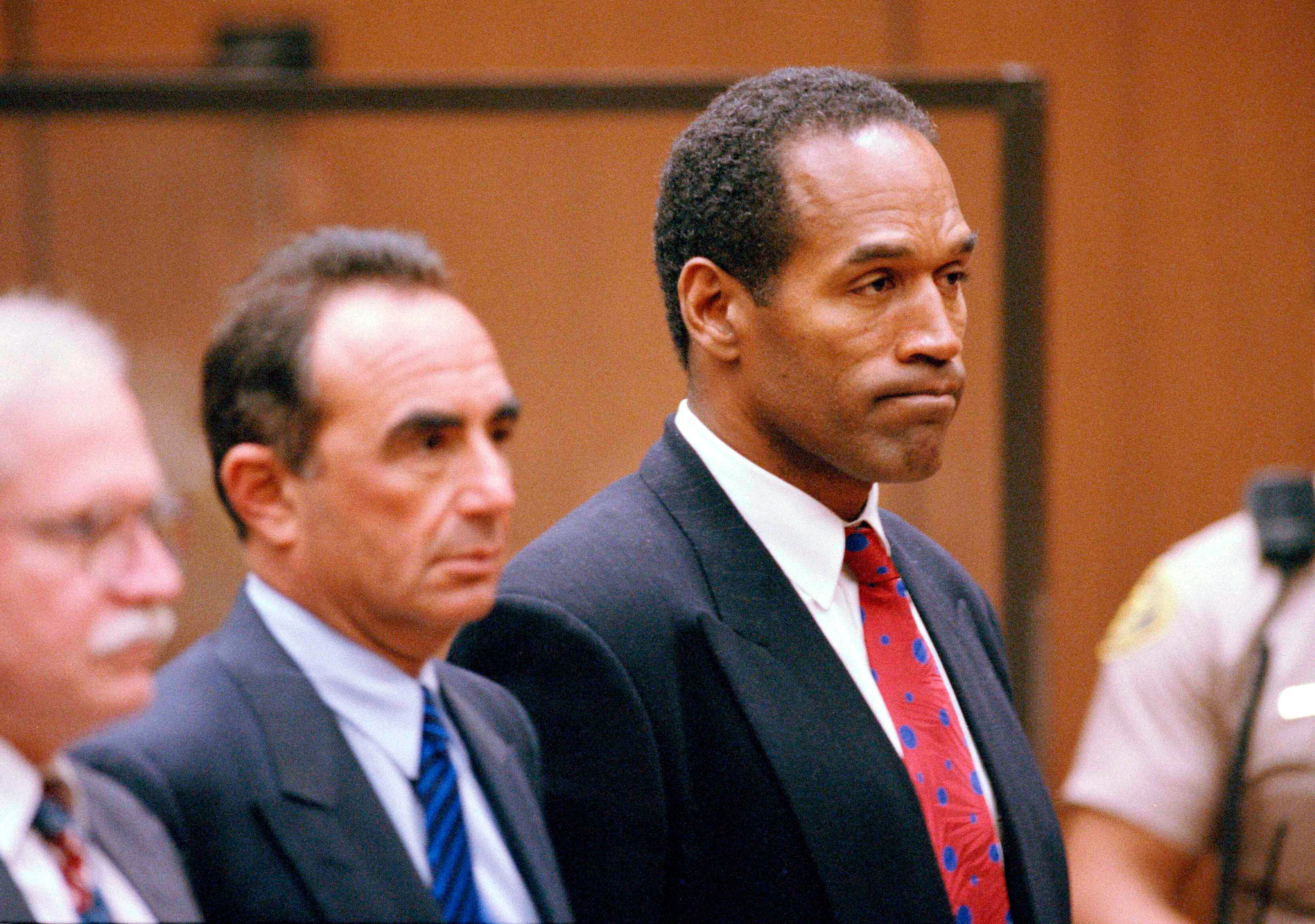 O.J. Simpson stands as he listens to Municipal Judge Kathleen Kennedy-Powell as she reads her decision to hold him over for trial on July 8, 1994, in connection with the June 12 slayings of his ex-wife Nicole Brown Simpson and Ronald Goldman. Simpson, the decorated football superstar and Hollywood actor who was acquitted of charges he killed his former wife and her friend but later found liable in a separate civil trial, has died. He was 76.