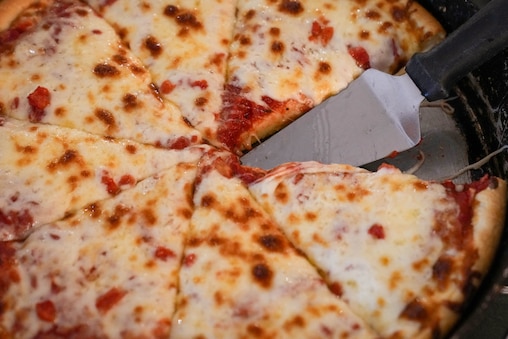 Customer Jonathan Binstock orders a pizza at Armand's Pizzeria & Grille in Rockville, Md. on Wednesday, June 17, 2026. After more than 50 years in business, the pizza shop will close its doors this week.