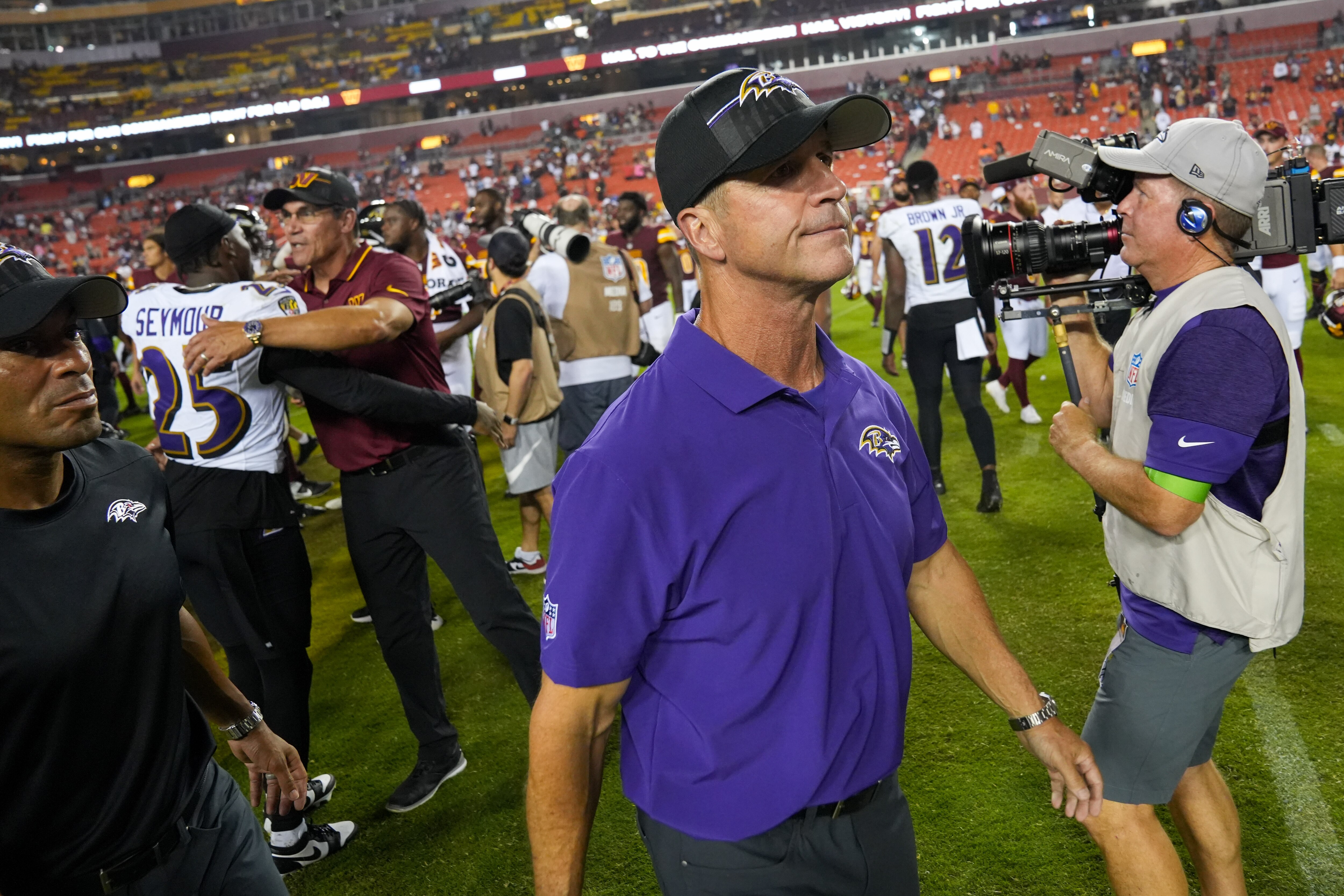 Baltimore Ravens head coach John Harbaugh walks back to the sidelines after congratulating Washington Commanders head coach Ron Rivera on his team’s preseason win at FedEx Field on Monday, Aug. 21, 2023.