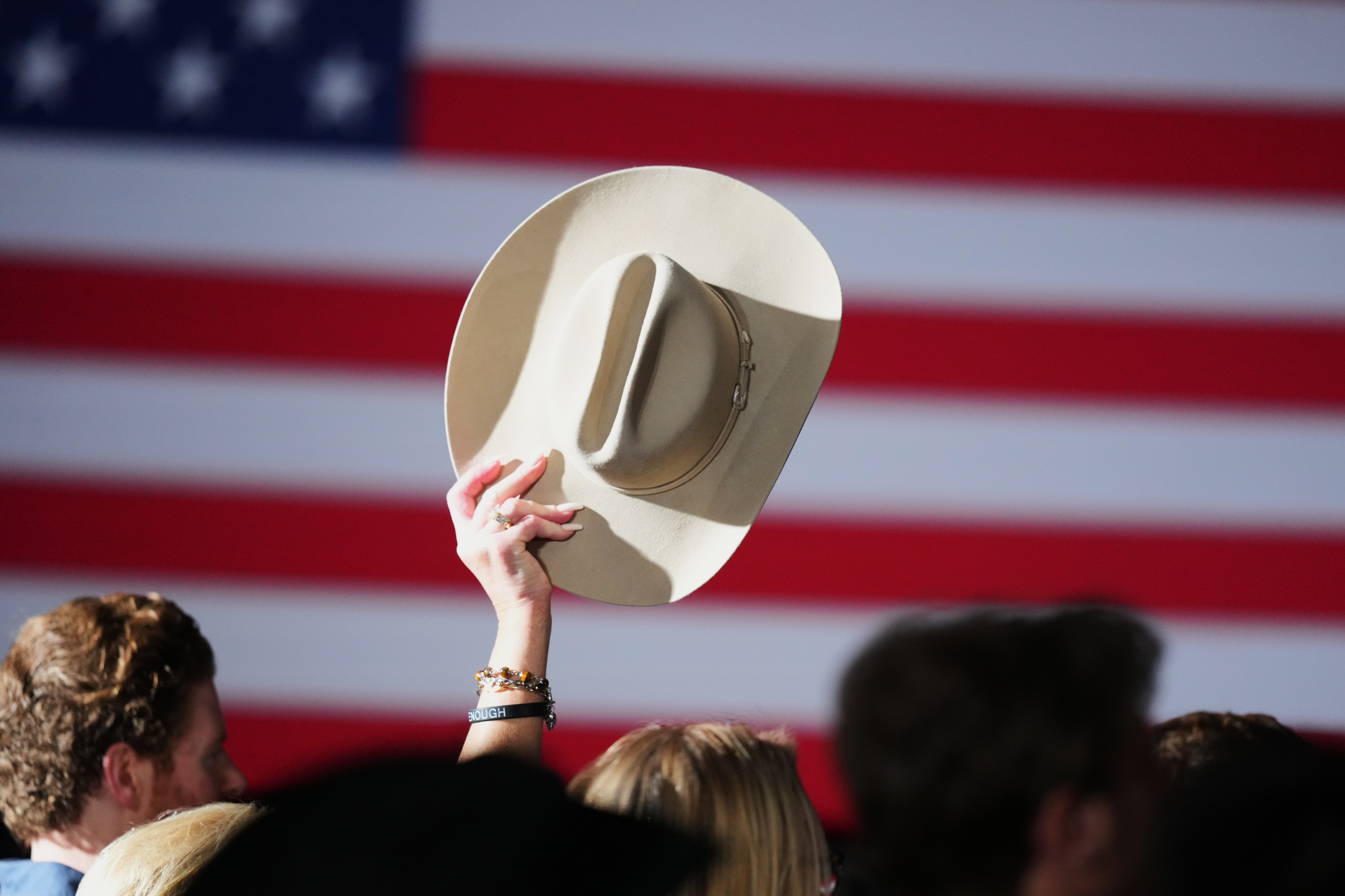 A supporter raises their hat at an election night primary watch party for Texas Attorney General Ken Paxton.