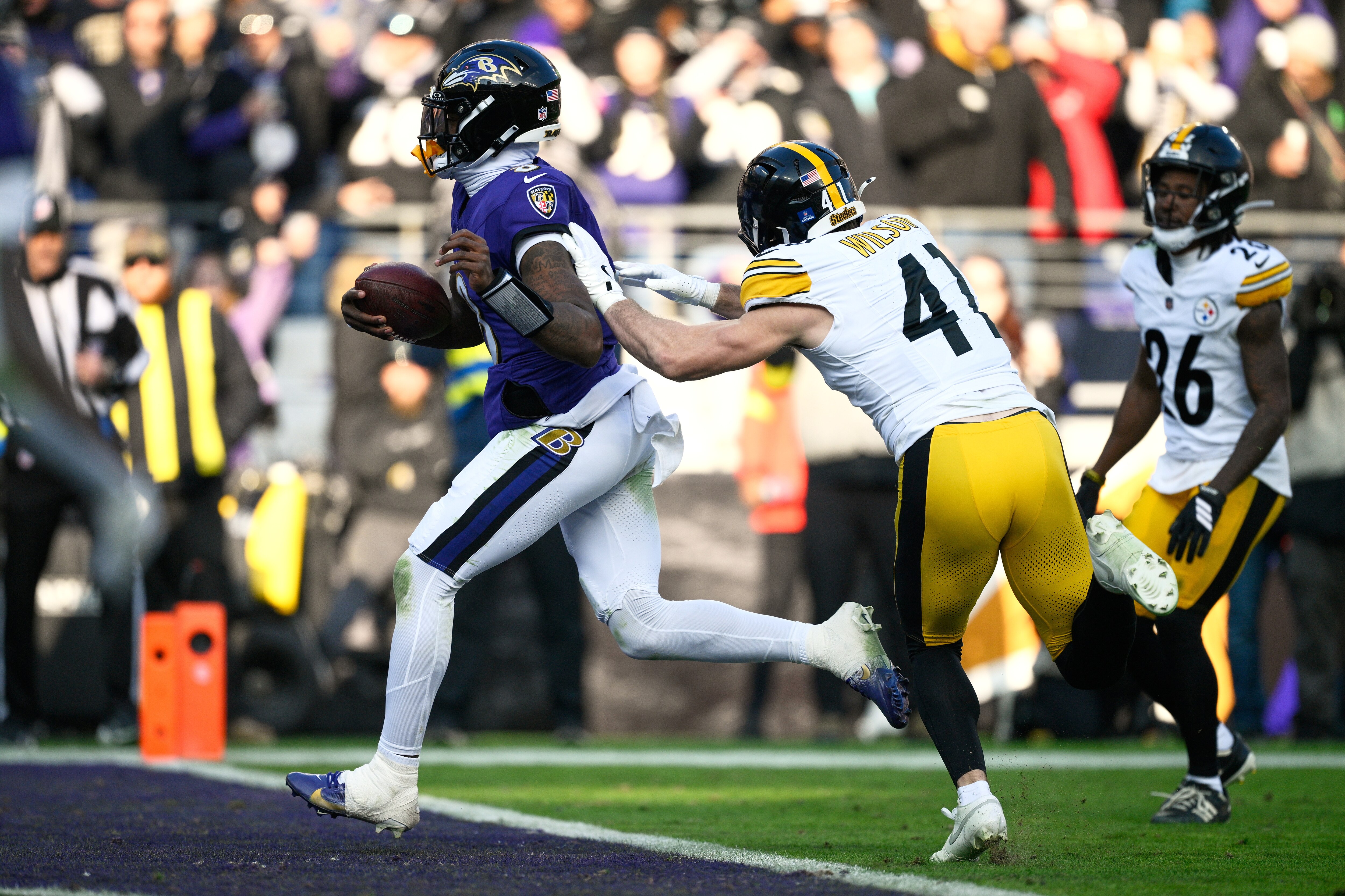 Baltimore Ravens quarterback Lamar Jackson (8) runs to the endzone for a touchdown as Pittsburgh Steelers linebacker Payton Wilson (41) defends during the first half of an NFL football game, Sunday, Dec. 7, 2025, in Baltimore.