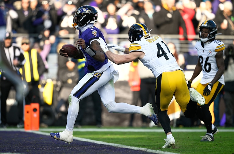 Baltimore Ravens quarterback Lamar Jackson (8) runs to the endzone for a touchdown as Pittsburgh Steelers linebacker Payton Wilson (41) defends during the first half of an NFL football game, Sunday, Dec. 7, 2025, in Baltimore.