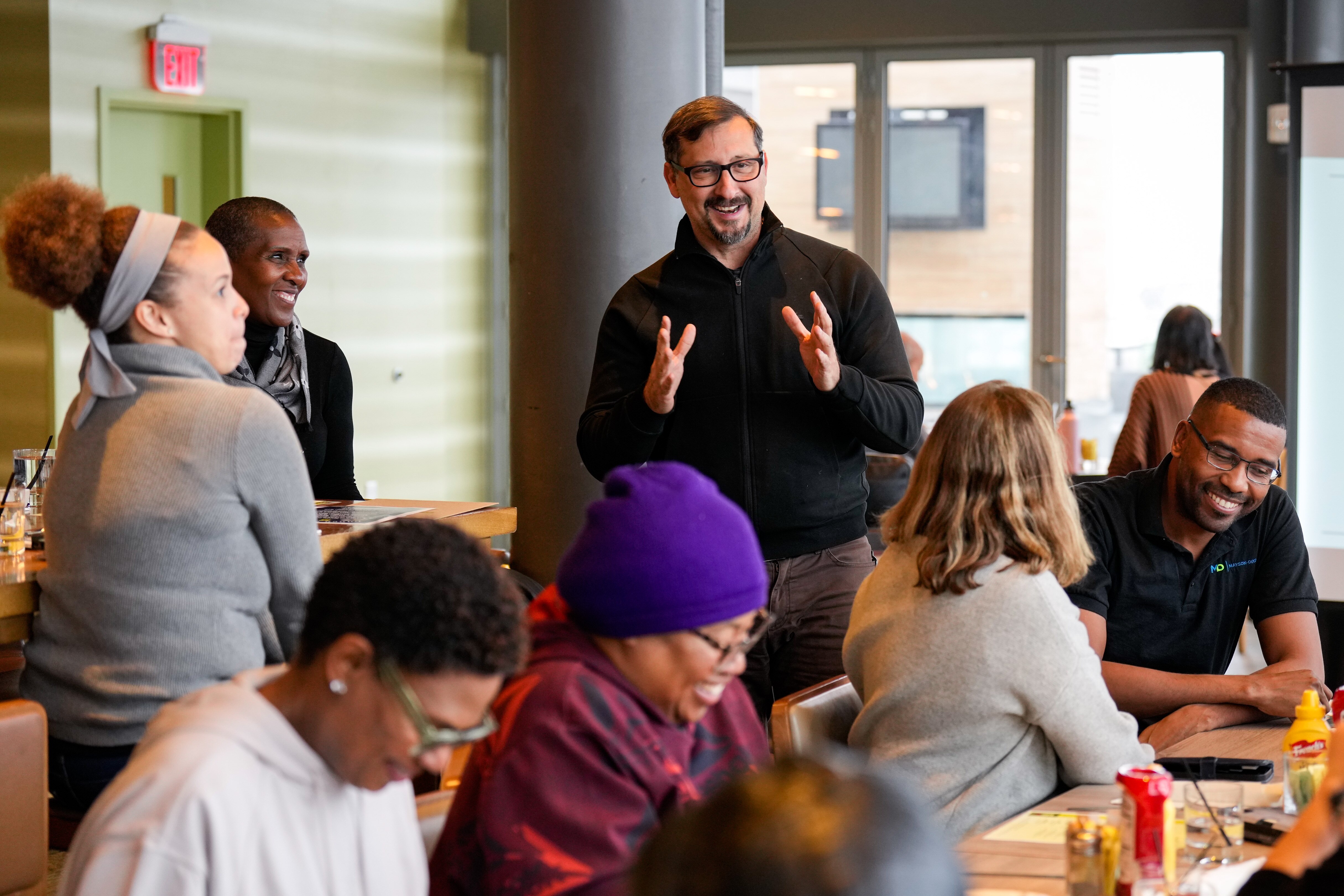 EPA Regional Administrator Adam Ortiz, center, speaks with community residents during a tour of Baltimore.