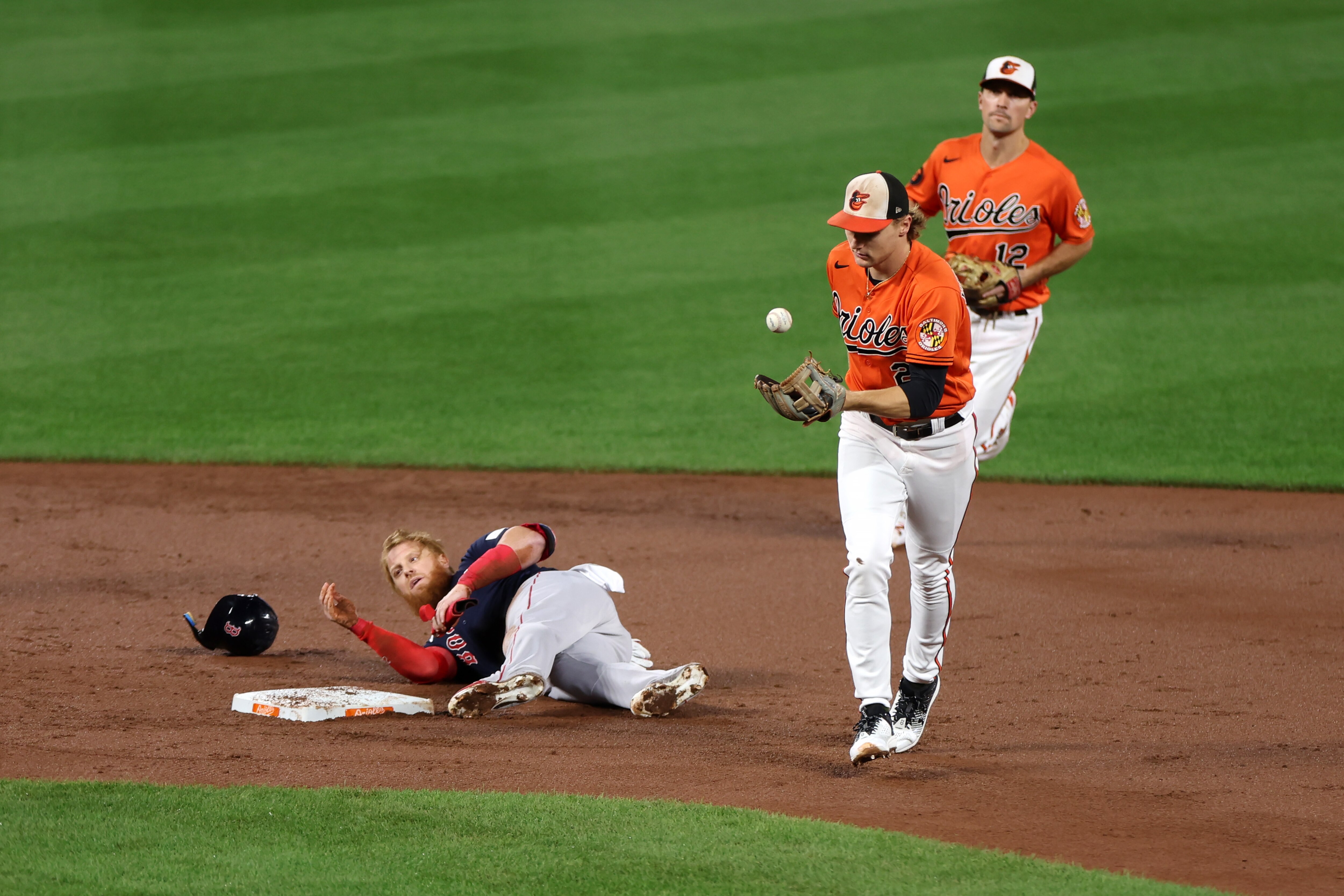 Gunnar Henderson flips the ball into his glove after tagging out Justin Turner of the Red Sox on an attempted steal to end the top of the third inning.