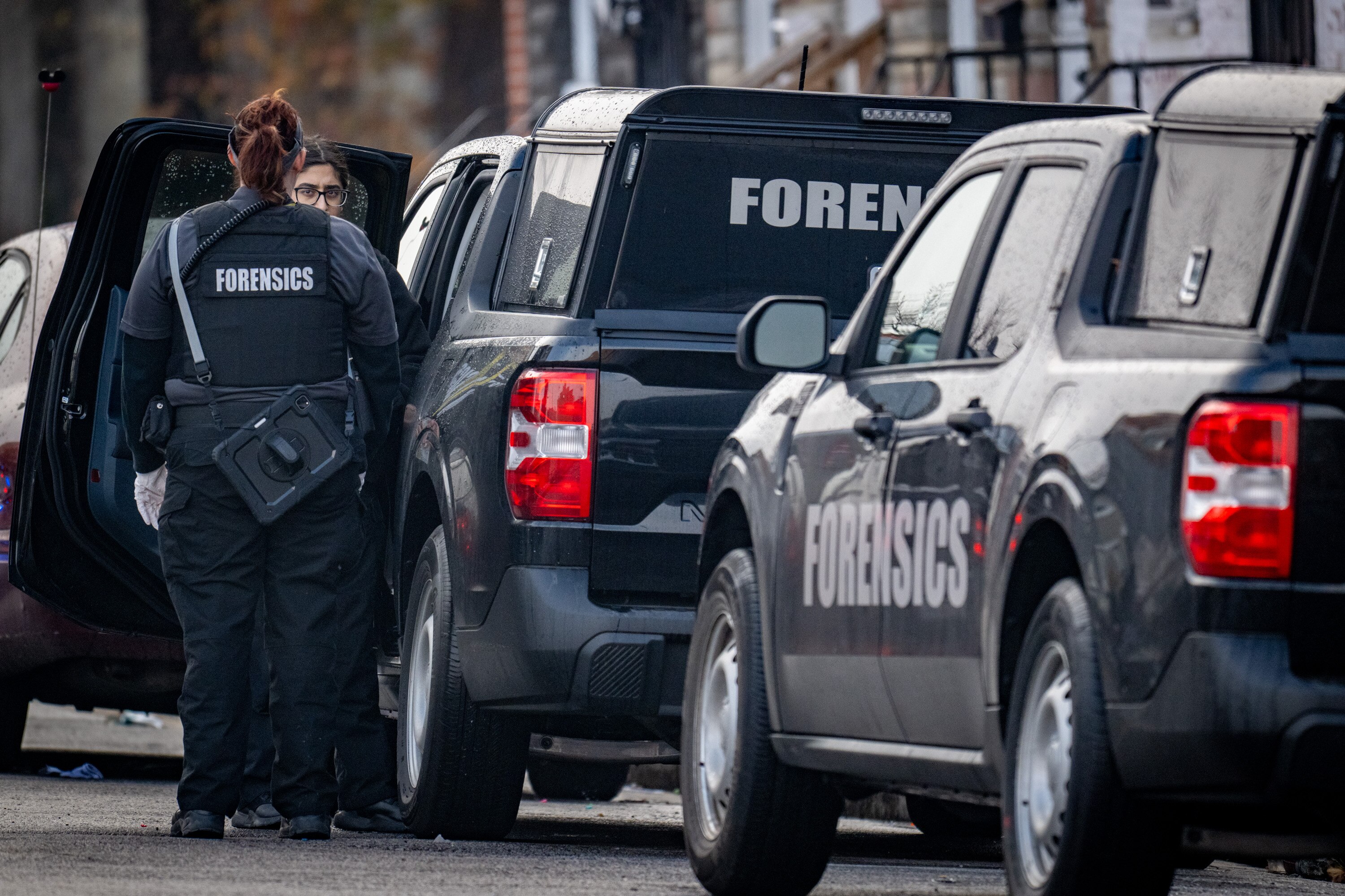 Forensics technicians arrive Saturday morning after a quadruple shooting in a residence on the 1800 block of McHenry Street in the Carrollton Ridge neighborhood.