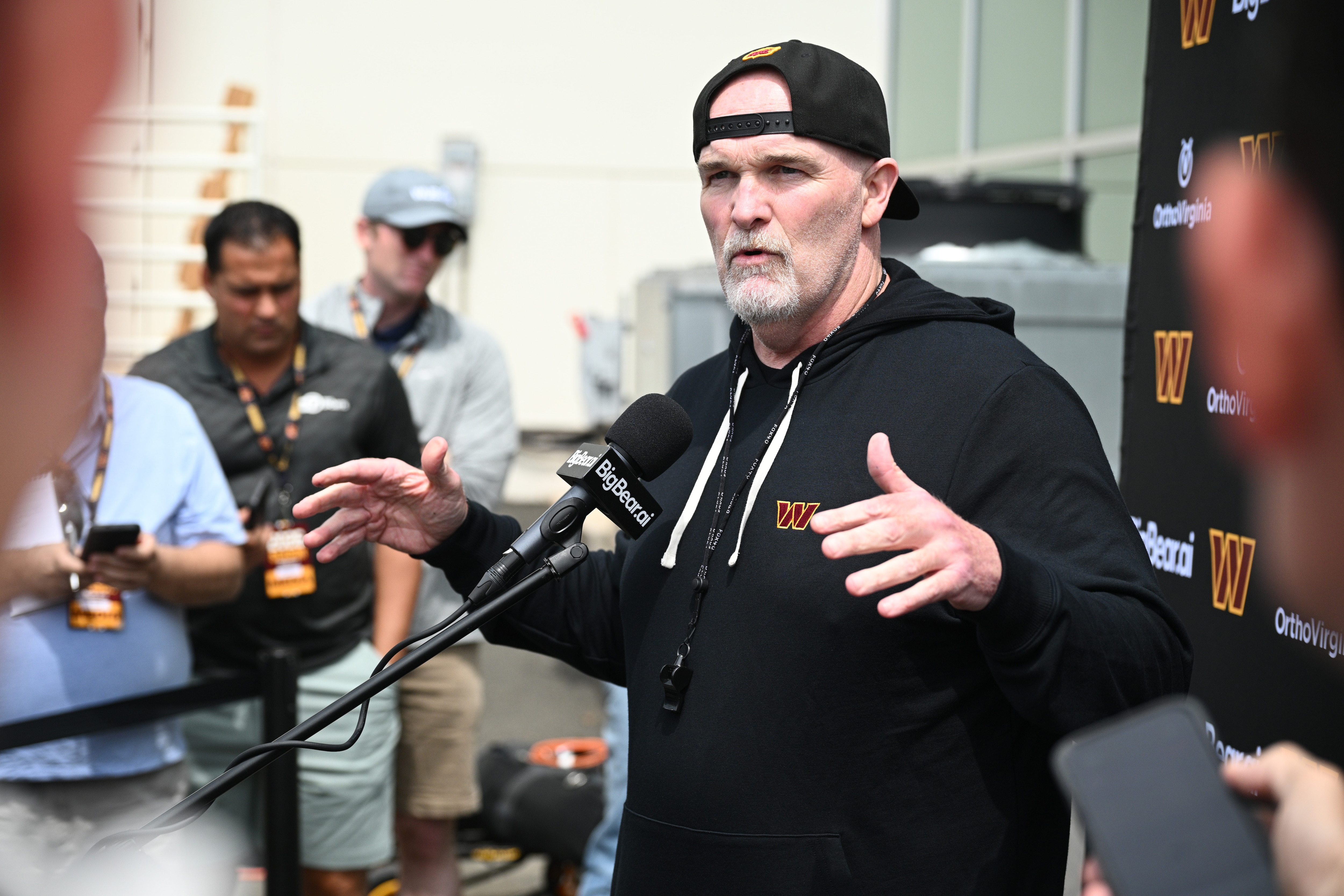Washington Commanders head coach Dan Quinn speaks to the media before practice on June 9.
