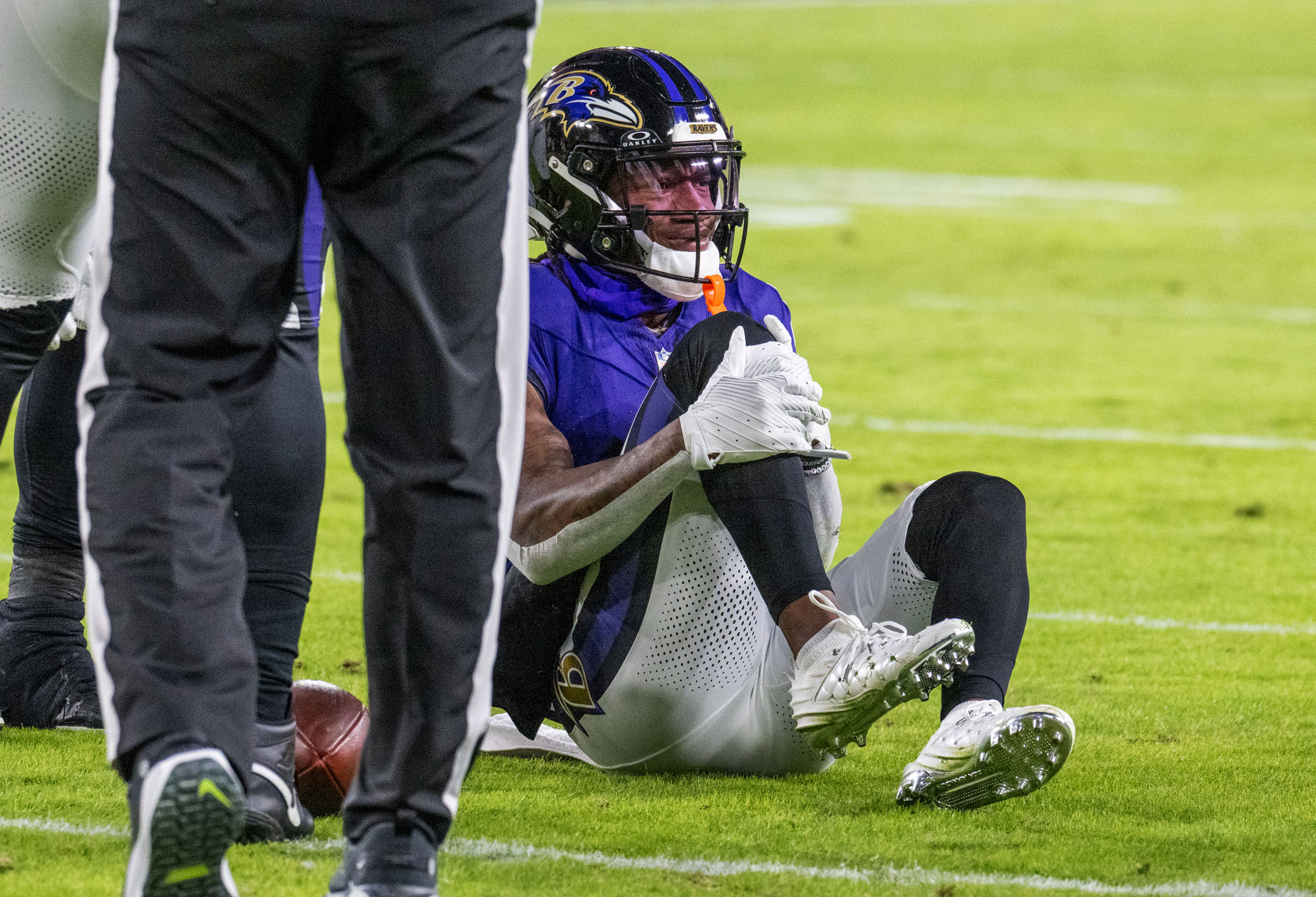 Wide receiver Zay Flowers (4) holds his leg after being injured in the second quarter against the Cleveland Browns.