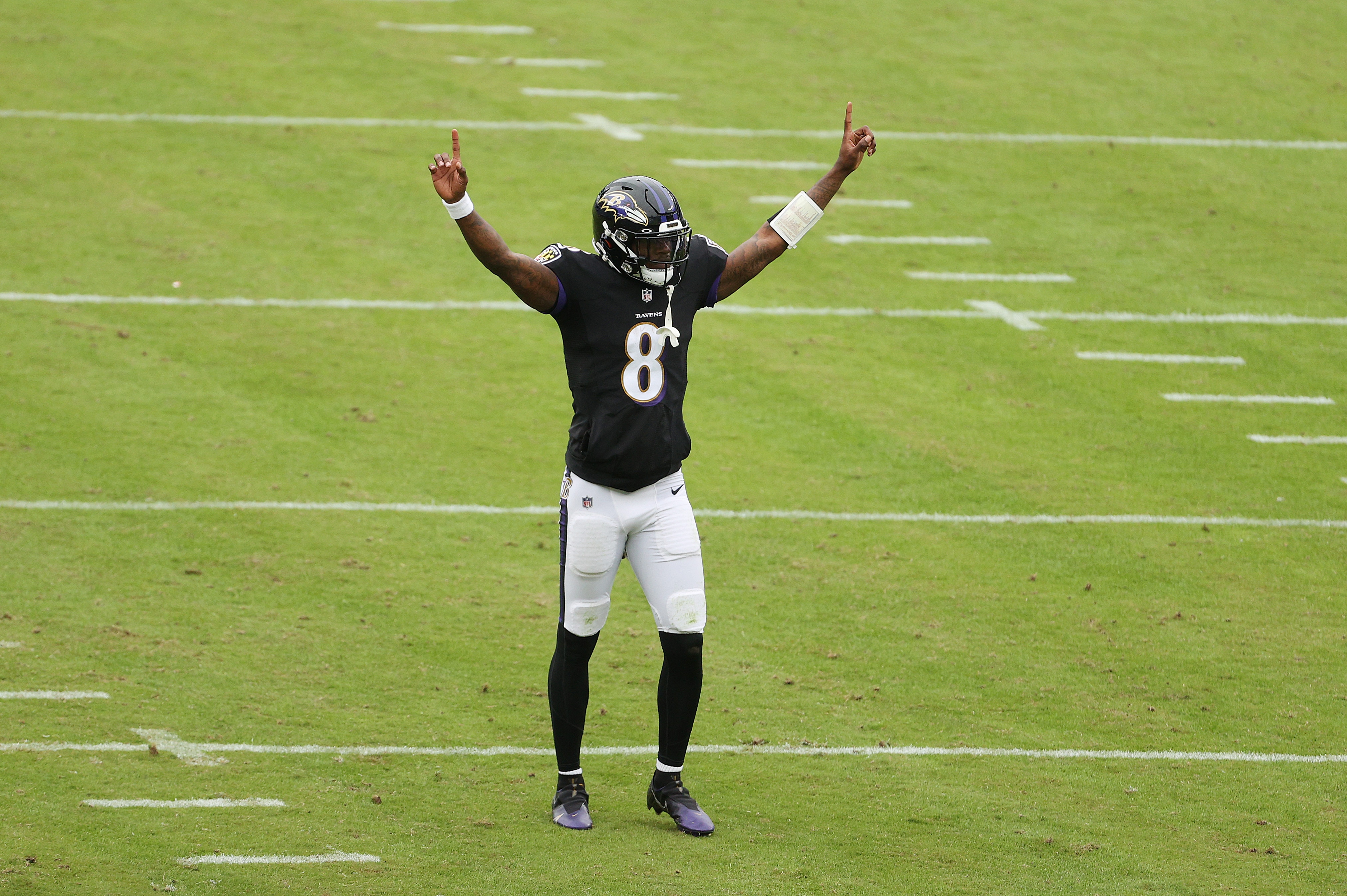 Lamar Jackson #8 of the Baltimore Ravens celebrates a second quarter touchdown by J.K. Dobbins #27 against the Tennessee Titans  during the game at M&T Bank Stadium on November 22, 2020 in Baltimore, Maryland.