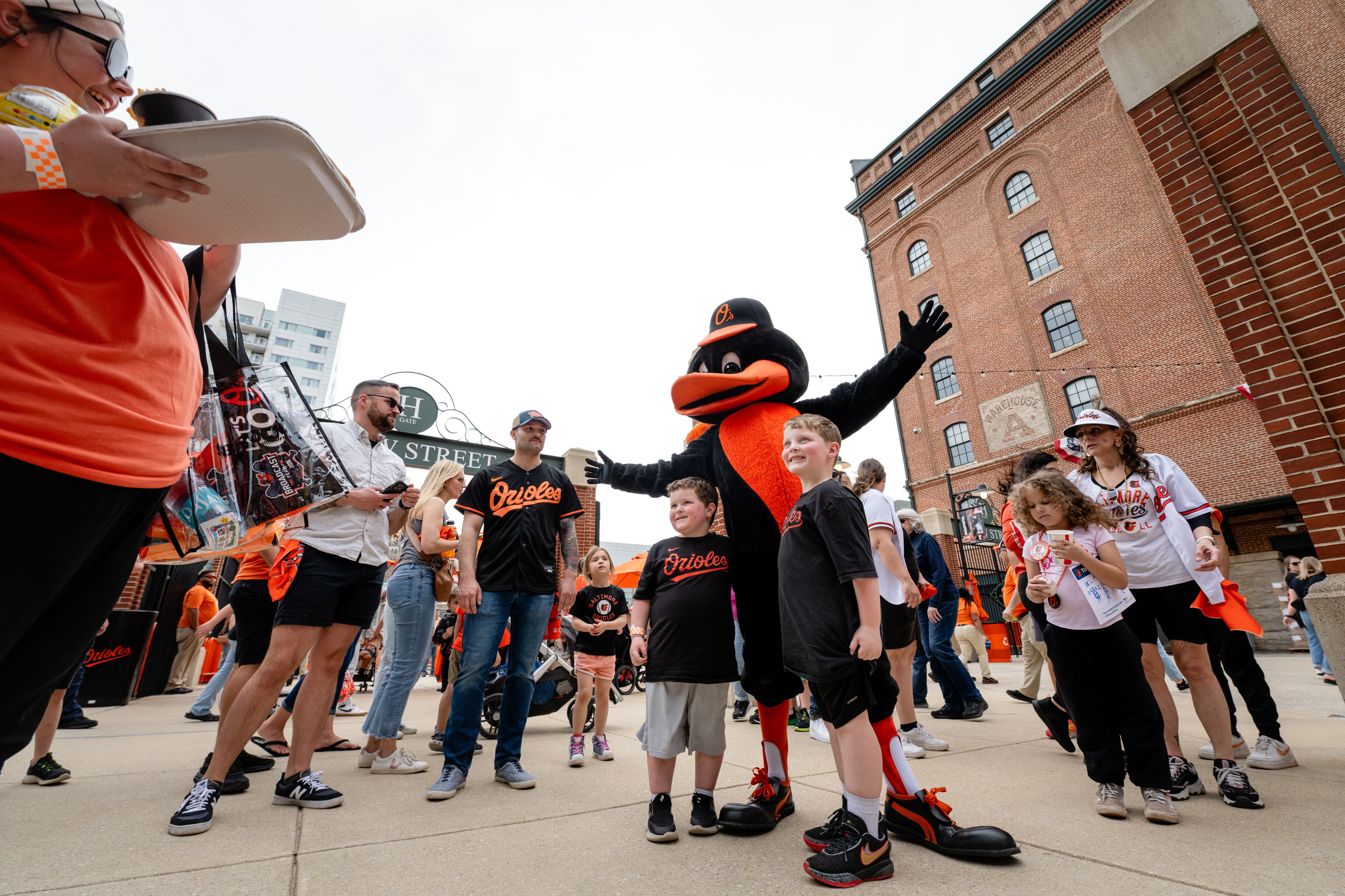 The Orioles’ mascot poses with fans during the team’s Eutaw Street Block Party on Saturday.