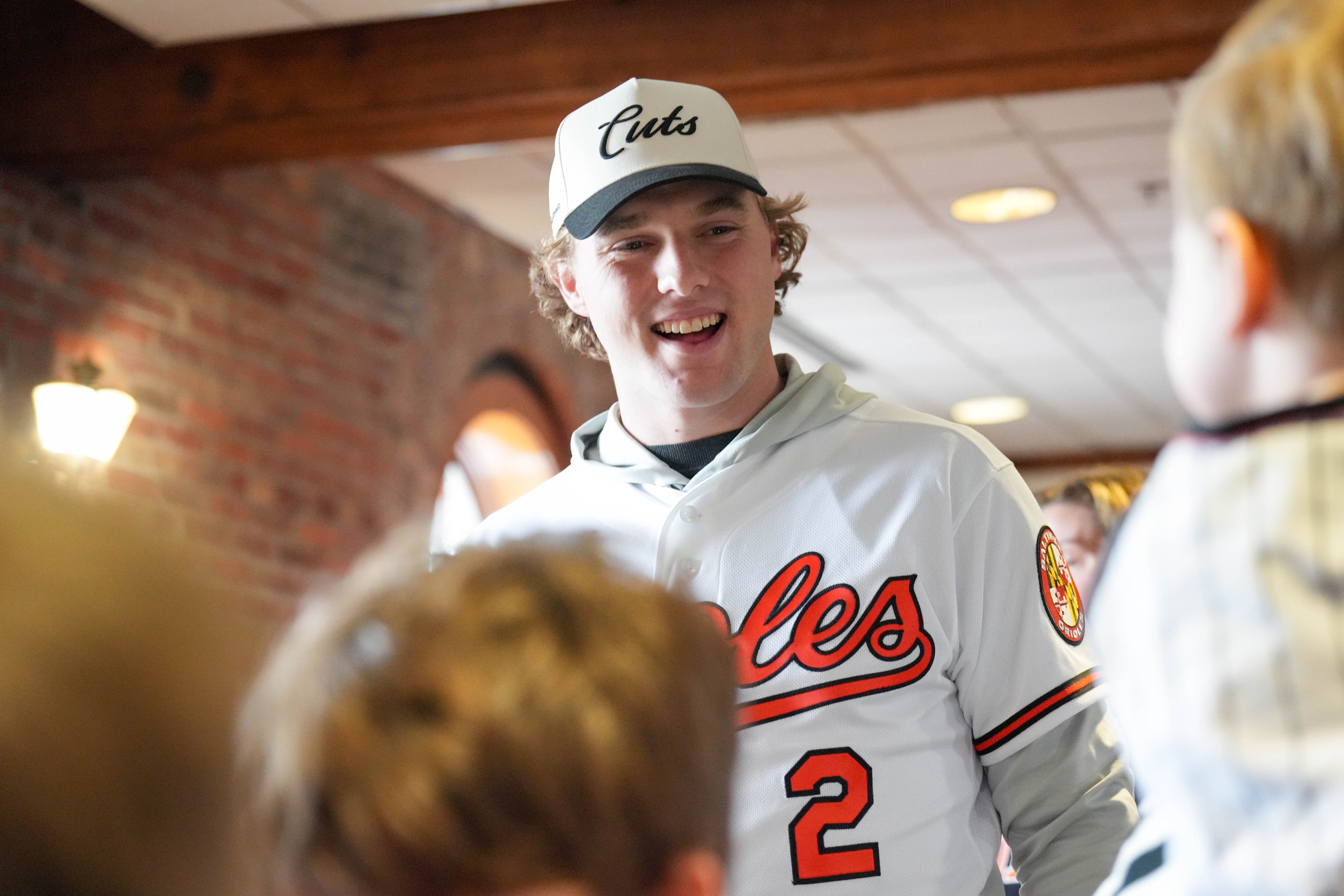 Orioles shortstop Gunnar Henderson, greeting guests during a Birdland Caravan event Friday, said he hurt his shoulder early last season.