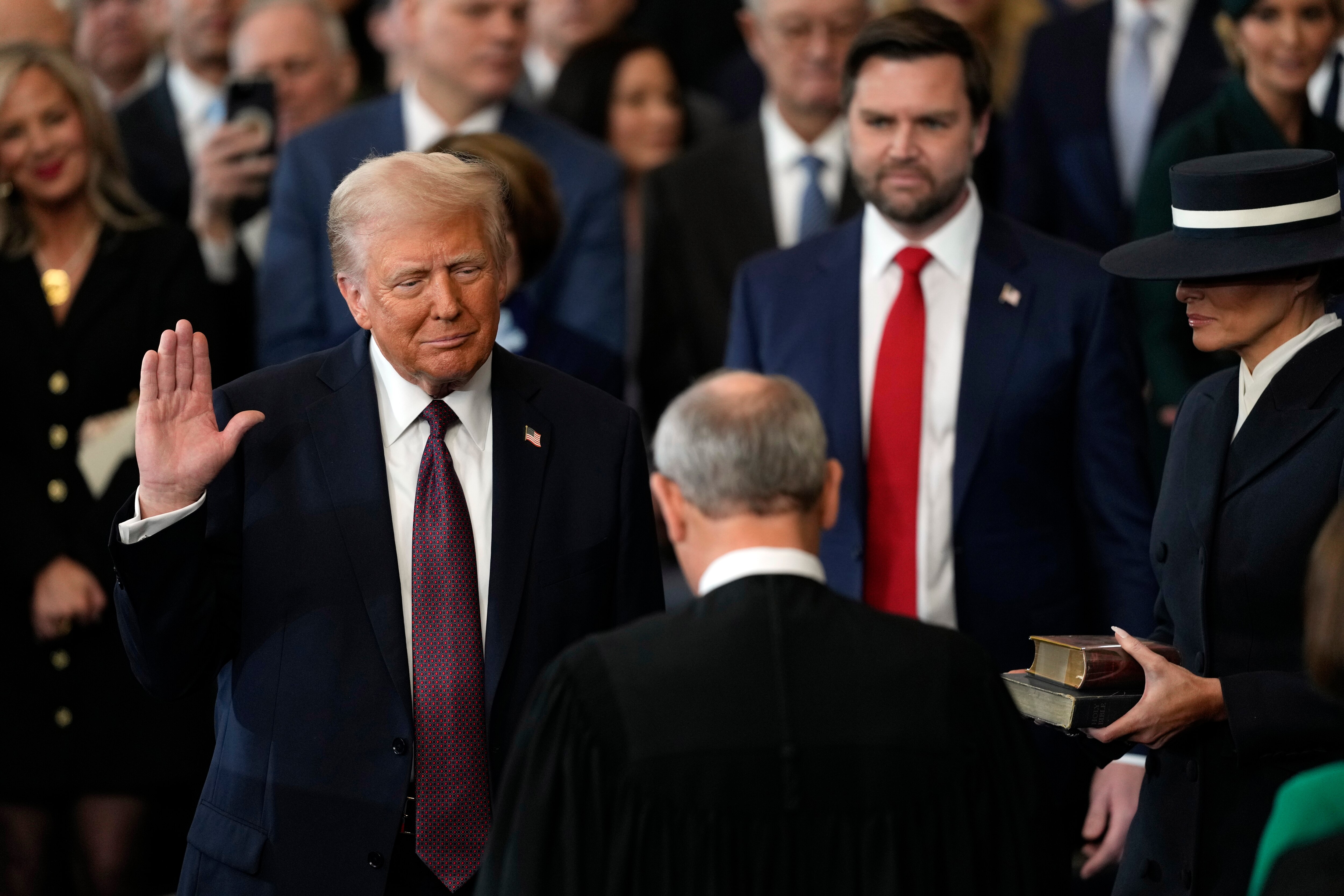 WASHINGTON, DC - JANUARY 20:  Donald Trump is sworn into office by Supreme Court Chief Justice John Roberts as Melania Trump holds the Bible  in the U.S. Capitol Rotunda on January 20, 2025 in Washington, DC. Donald Trump takes office for his second term as the 47th president of the United States. (Photo by Julia Demaree Nikhinson - Pool/Getty Images)