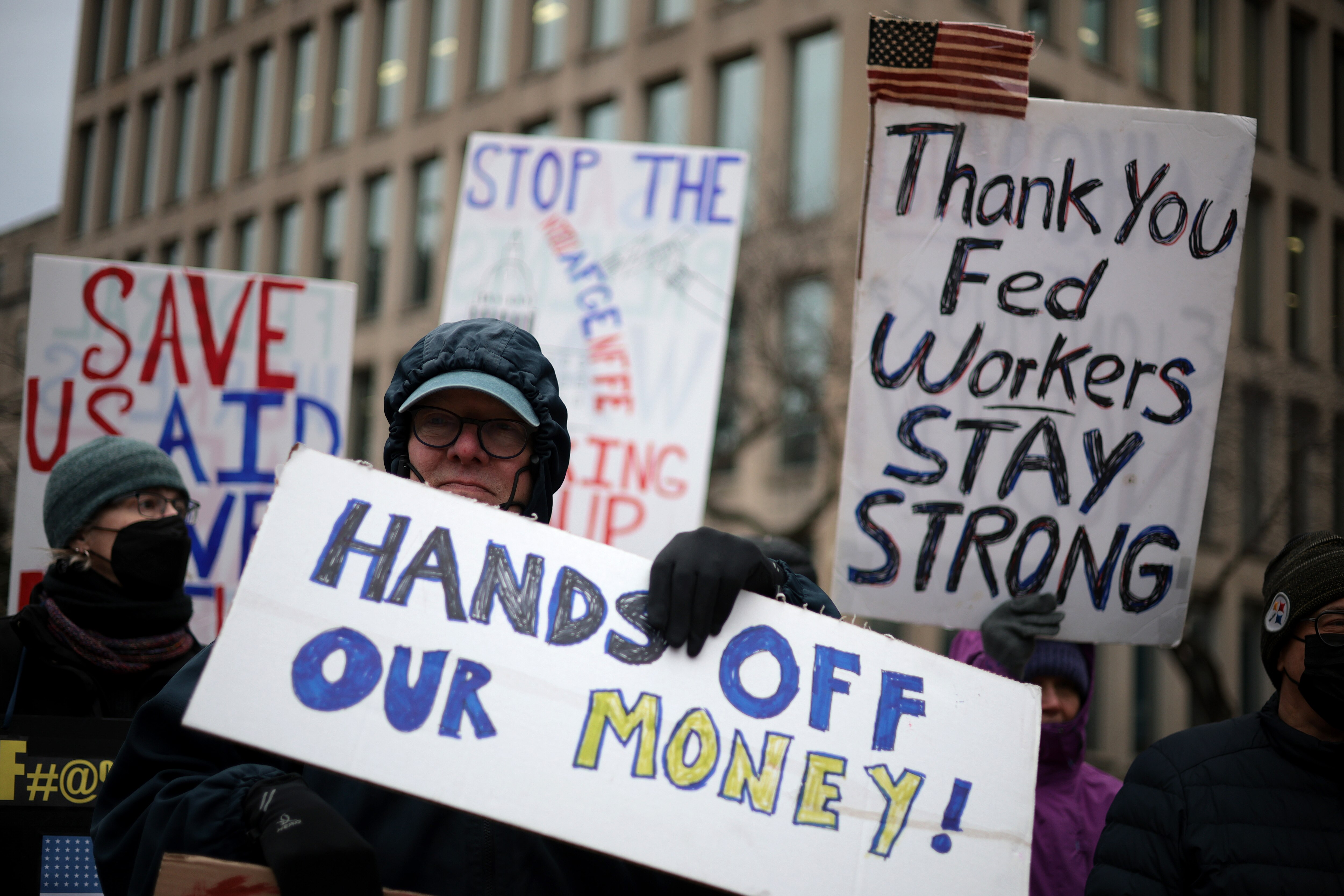 WASHINGTON, DC - FEBRUARY 05: Protesters rally outside of the Theodore Roosevelt Federal Building headquarters of the U.S. Office of Personnel Management on February 05, 2025 in Washington, DC. The group of federal employees and supporters are protesting against Elon Musk, tech billionaire and head of the Department of Government Efficiency (DOGE), and his aids who have been given access to federal employee personal data and have allegedly locked out career civil servants from the OPM computer systems. (Photo by Alex Wong/Getty Images)