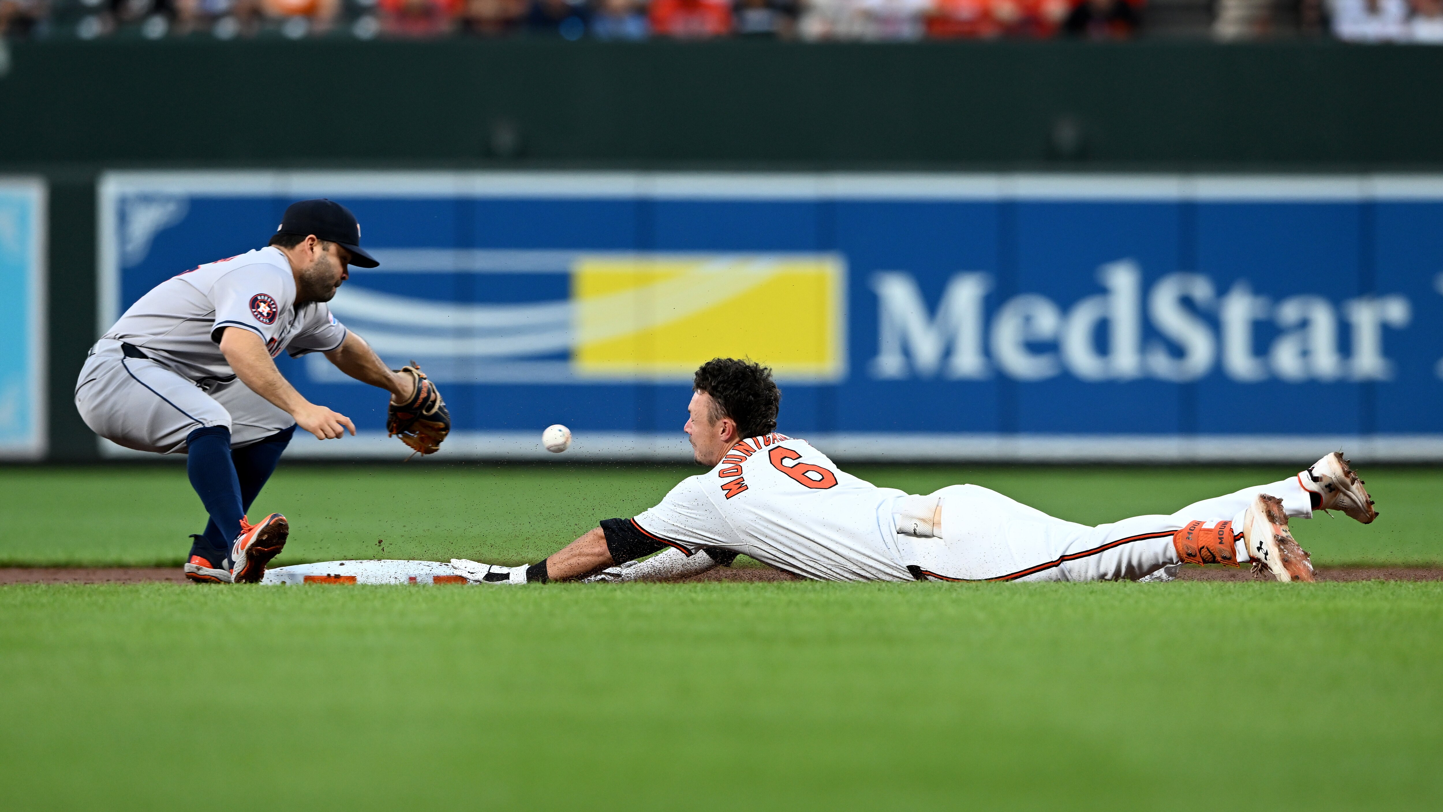 BALTIMORE, MARYLAND - AUGUST 22: Ryan Mountcastle #6 of the Baltimore Orioles slides into second base with a double in the second inning ahead of the throw to Jose Altuve #27 of the Houston Astros at Oriole Park at Camden Yards on August 22, 2024 in Baltimore, Maryland. (Photo by Greg Fiume/Getty Images)