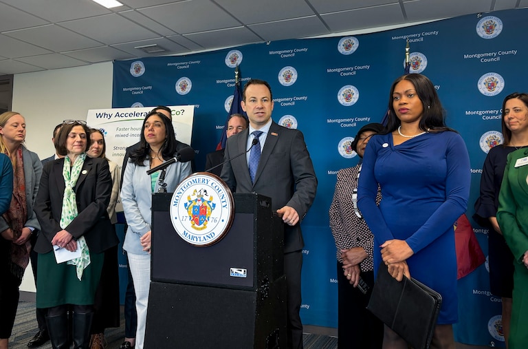 Montgomery County Council members Andrew Friedson, center, and Laurie-Anne Sayles, right, introduce a set of bills that aim to cut red tape for some development projects during a press conference in Rockville on Tuesday.