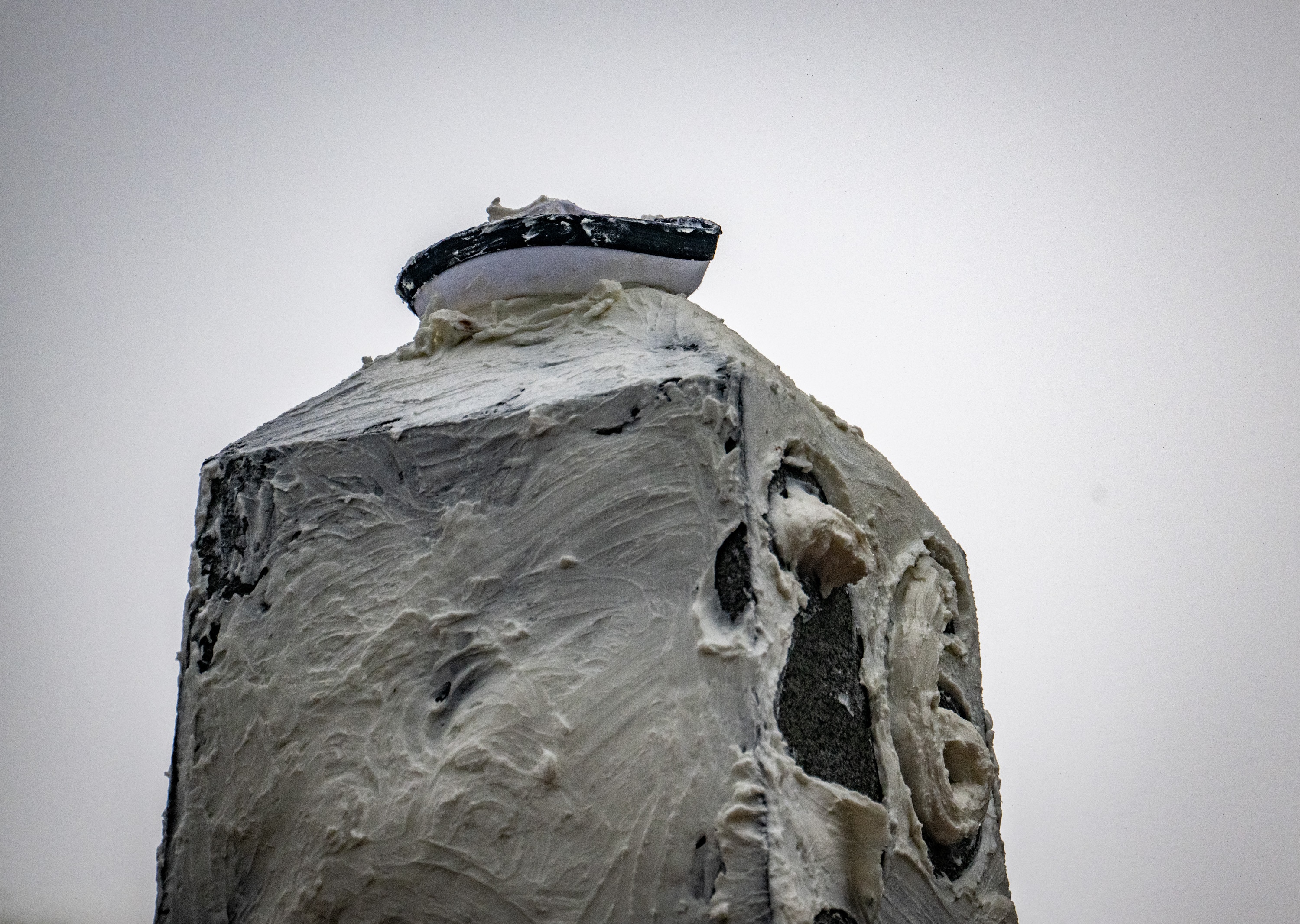 A plebe’s dixie cup sits atop the Herndon Monument covered in vegetable shortening during the annual Herndon Monument climb at the U.S. Naval Academy.