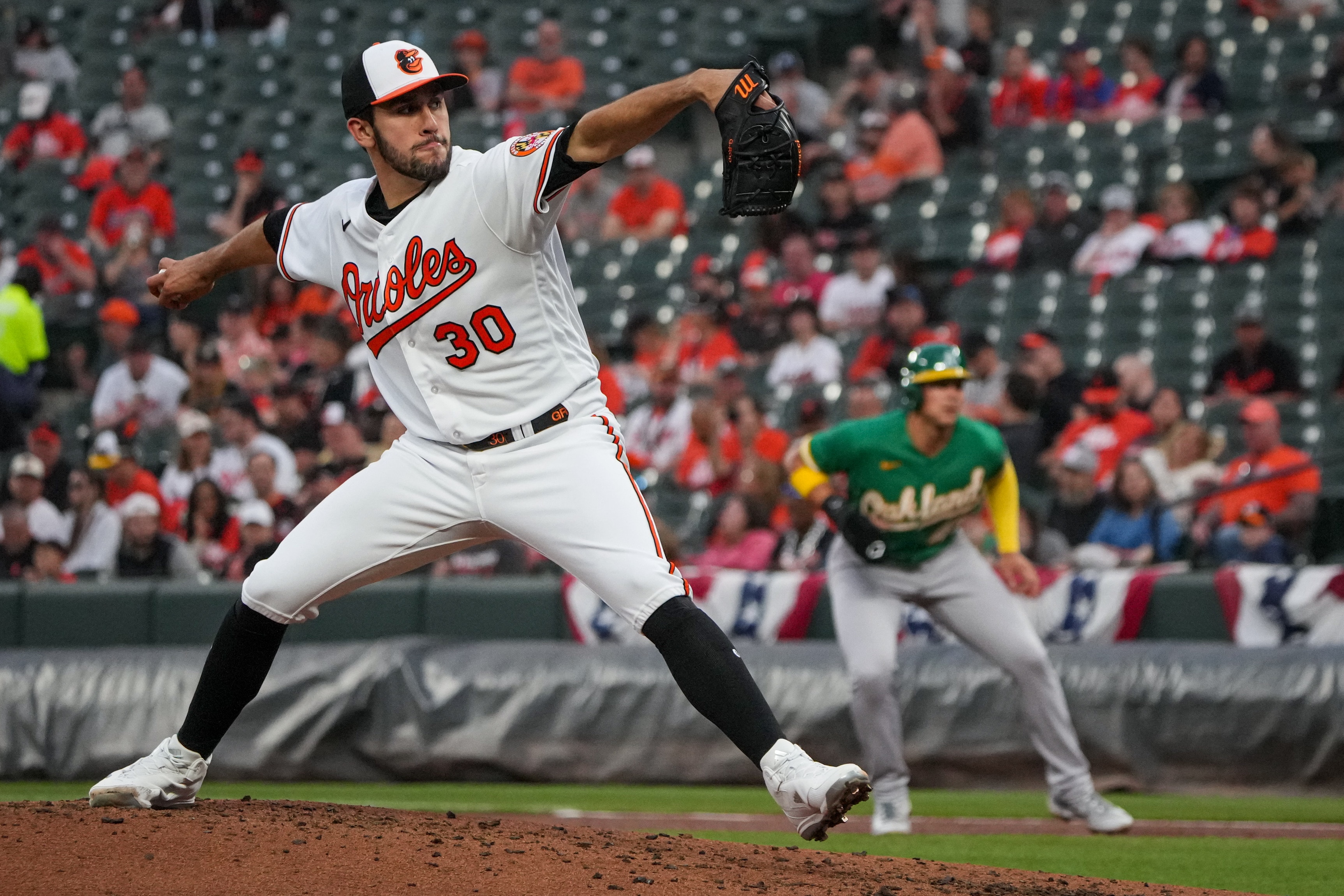 Baltimore Orioles starting pitcher Grayson Rodriguez (30) delivers a pitch in a baseball game against the Oakland Athletics at Camden Yards on Tuesday, April 11. The Orioles beat the Athletics, 12-8, in the second game of the series.