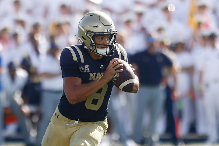 Navy quarterback Jackson Gutierrez (8) runs for a touchdown during the first half of an NCAA football game against Towson in Annapolis, Md., Saturday, Sept. 5, 2026. (AP Photo/Mike Buscher)
