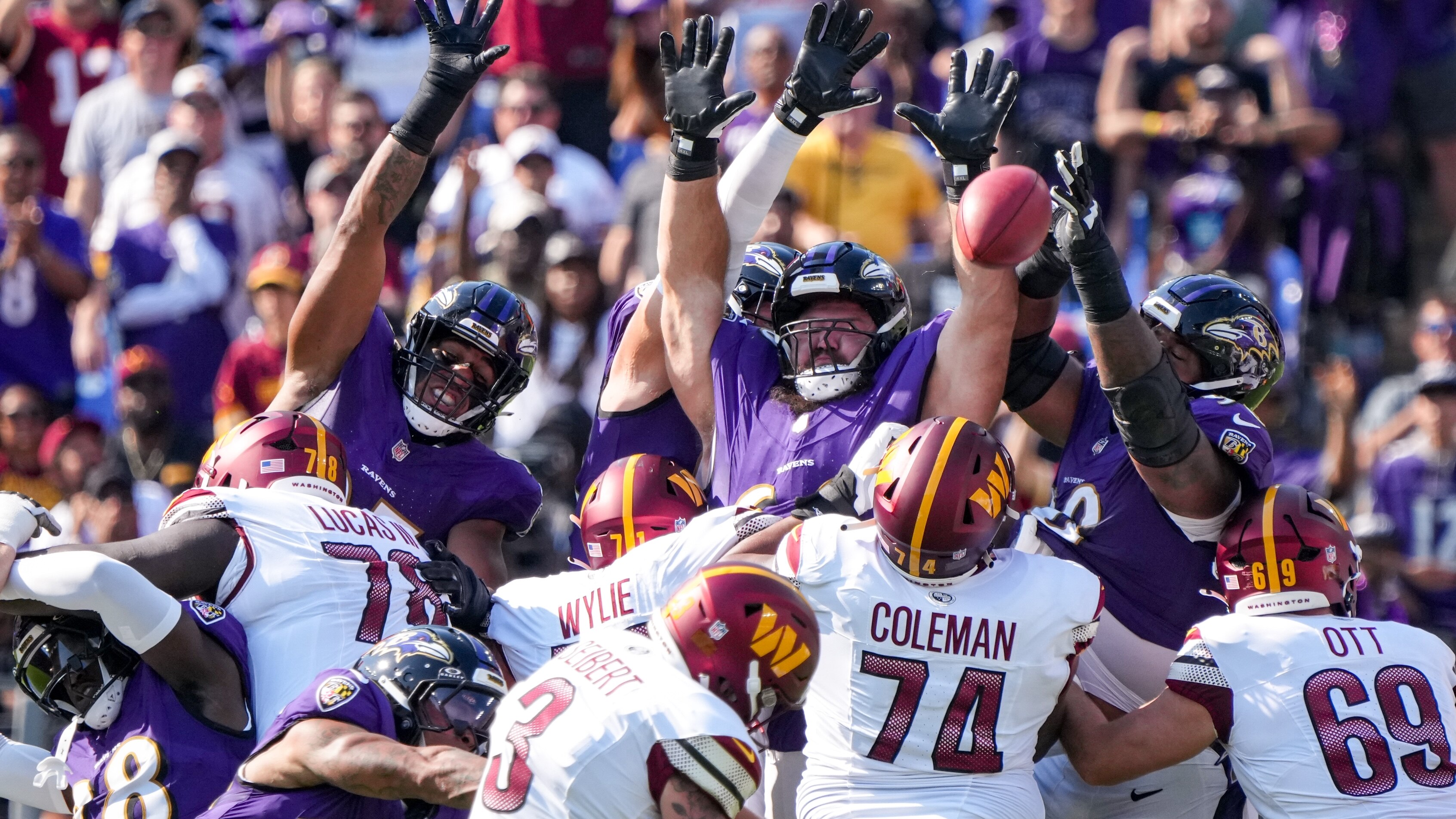 Baltimore Ravens defenders jump to try and block a Washington Commanders place kicker Austin Seibert (3) field goal attempt, which went wide, at the end of the second quarter in a game at M&T Bank Stadium in Baltimore on Sunday, October 13, 2024.