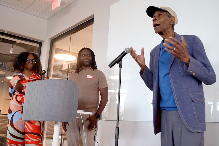 Donald Waugh, right, speaks at an Arabbers celebration in his honor last fall at the University of Maryland, Baltimore biotech campus. He is joined by his daughter, Sonia Eaddy, left, and grandson Curtis Eaddy.